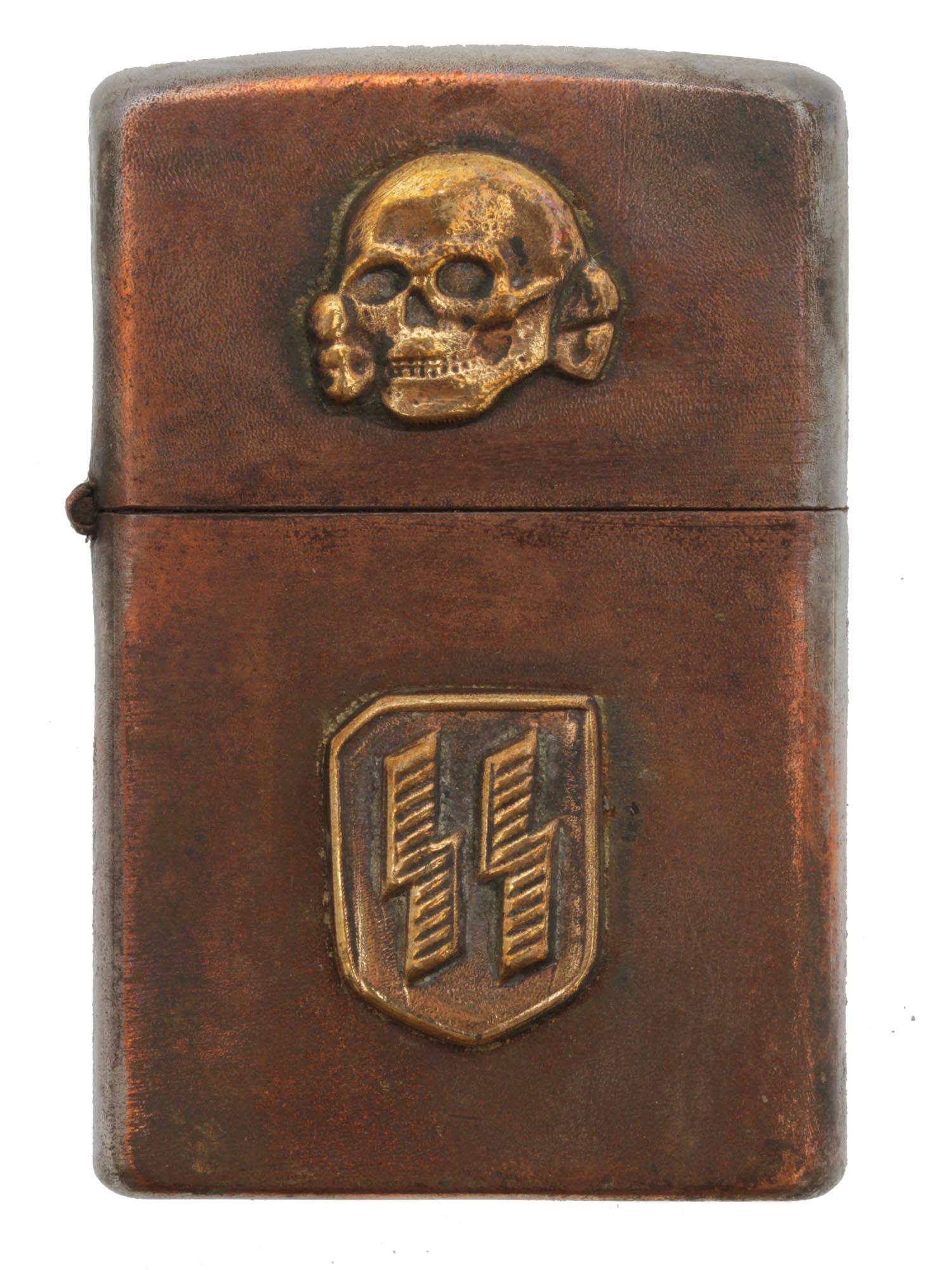 A WWII GERMAN 3RD REICH WAFFEN SS CIGARETTE LIGHTER: German Zippo style lighter with affixed Totenkopf on the top and SS rune insignia. Lighter is also RZM stamped on the bottom. Dimensions: 2 1/4 x 1 3/8 in.