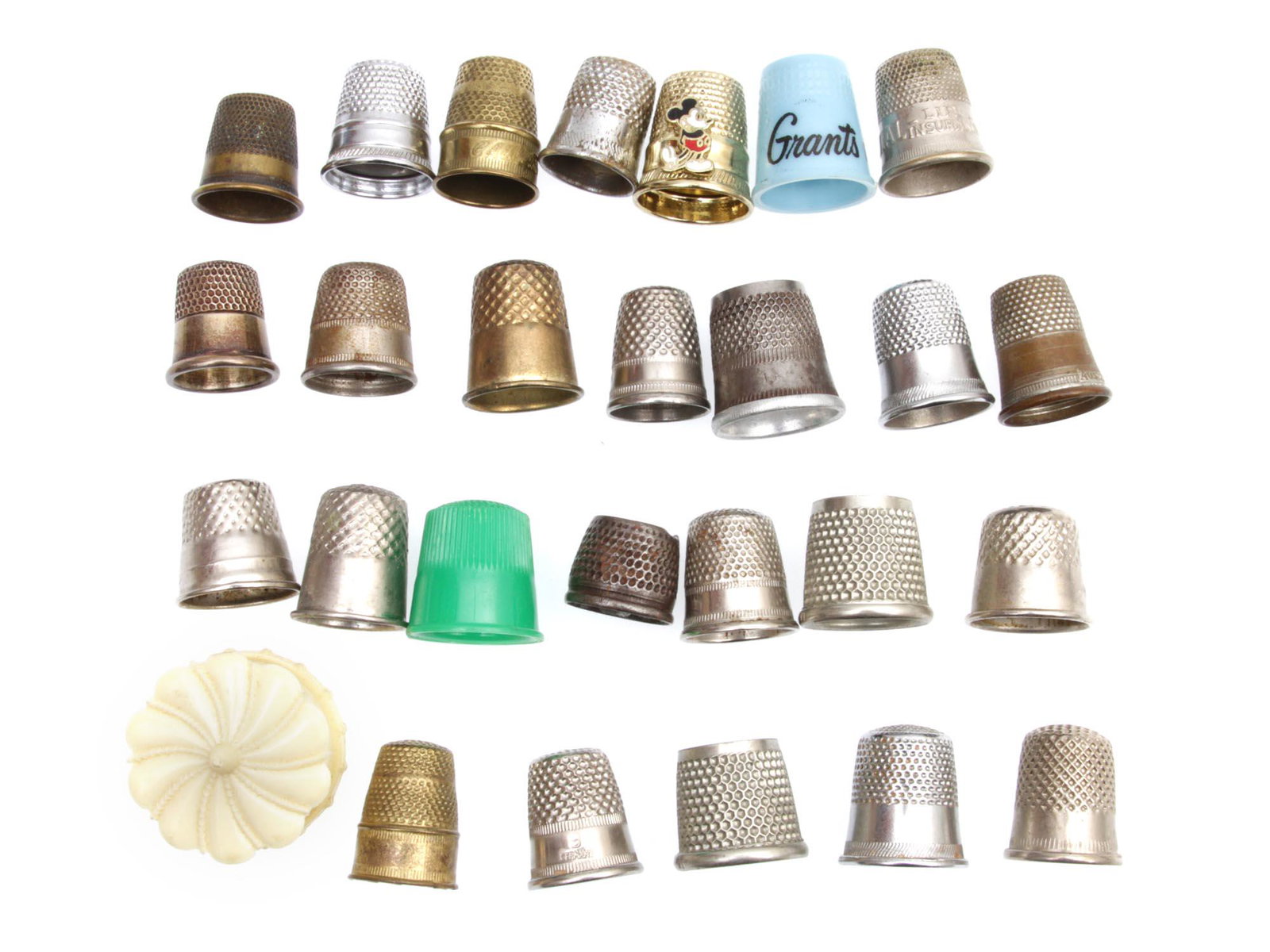 A LOT OF 26 VINTAGE THIMBLES PLATED & BRASS: A lot of vintage thimbles, some of them have the marking from origin Germany, Austria, and Italy, one of them marked sterling silver, the rest are made of different materials like brass, metal, and pl