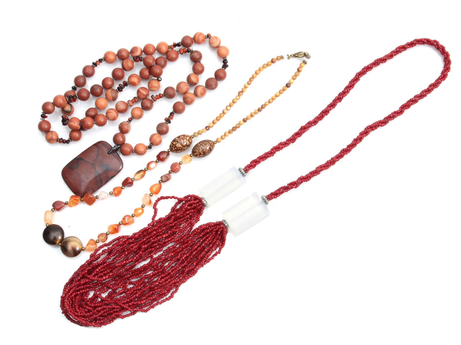 A SET OF VINTAGE JEWELRY NECKLACES: The set includes: natural agate beads, natural jasper beads with rectangular pendant, natural coral beads with elongated cube-shaped moonstone inserts. Dimensions: Smallest L: 20 1/4 in. Largest L: 30