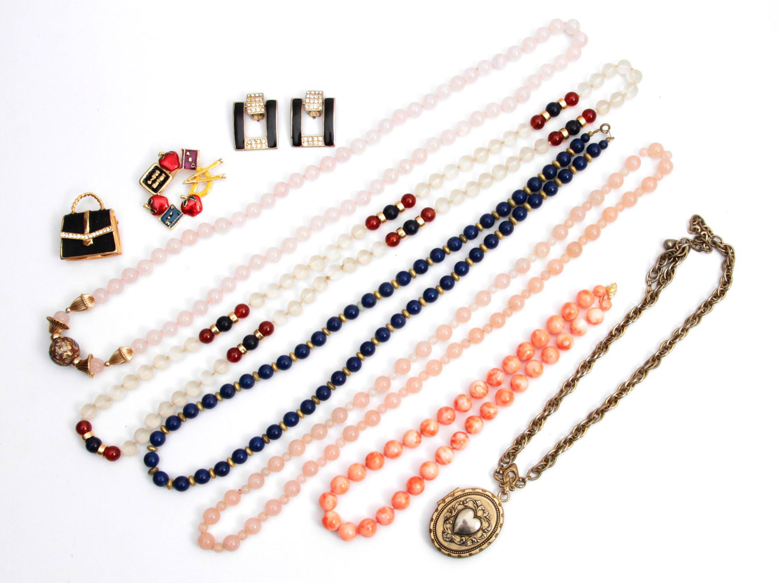 A LOT OF VINTAGE JEWELRY NECKLACE PINS: A lot of vintage jewelry items. Included: Rose quartz necklace, Blue Lapis necklace, Mottled pink Coral Necklace with 14K Gold Clasp, Clear frosted glass necklace, Necklace on a chain with locket pend