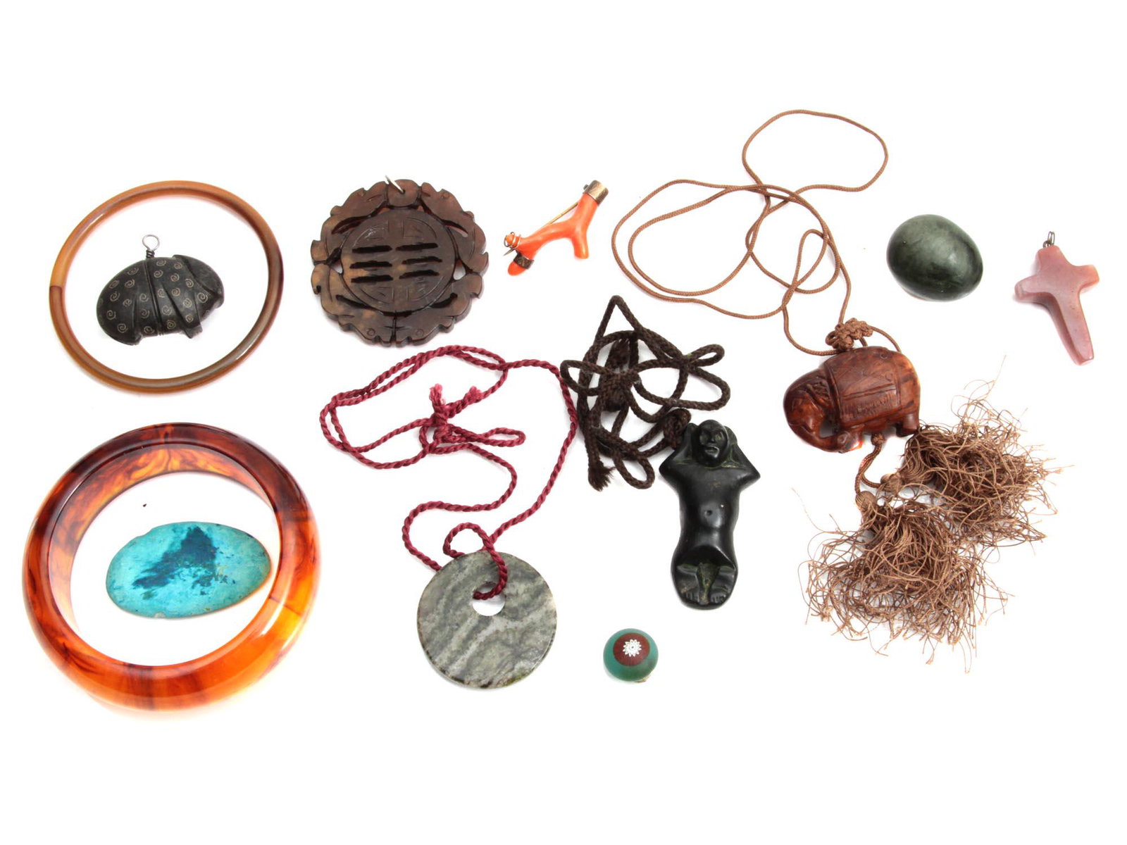 A LOT OF VINTAGE NECKLACE PENDANT BRACELET: A lot of vintage custom jewelry items. Included: two bakelite bracelets, Chinese jade pendant, rose quartz cross pendant, rose coral brooch, a necklace with a carved wood pendant in an elephant shape,
