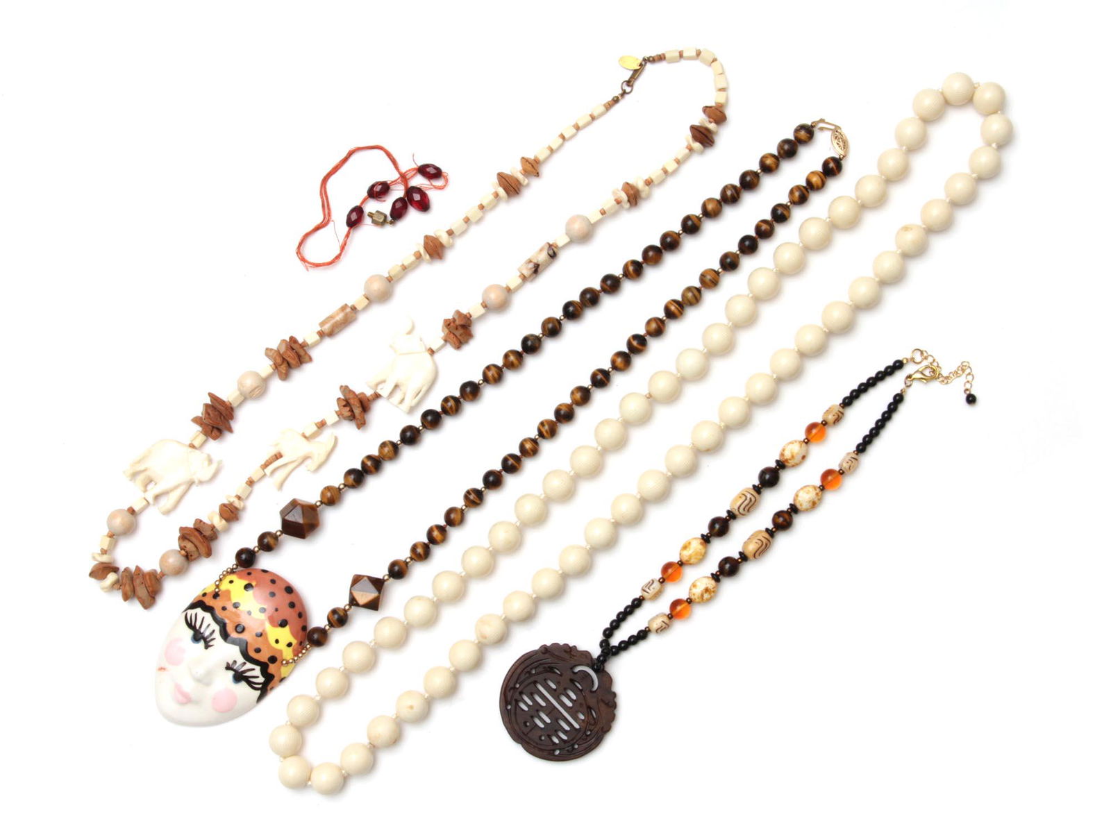 A VINTAGE JEWELRY NECKLACE BONE WOOD: A lot of vintage custom jewelry items. Included: Tiger eye beads necklace with a 14K gold clasp and enamel pendant, Bone and wood necklace with carved elephant figures by Miriam Haskell, Chinese brown