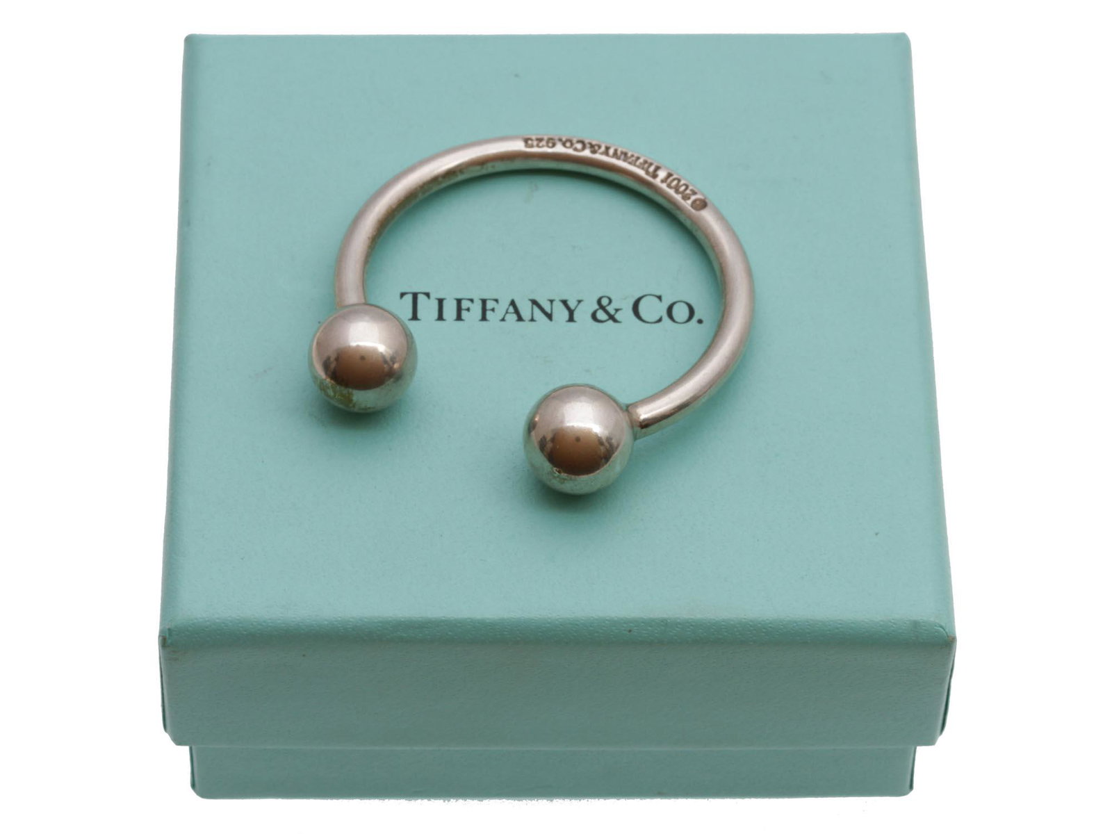 A VINTAGE TIFFANY & CO SILVER KEYRING 2001: A vintage Tiffany & Co sterling silver large key ring designed as functional semiring with two fixing balls at the ends. Marked with 2001, Tiffany & Co, 925 hallmarks. Complete with a brand Tiffany & 