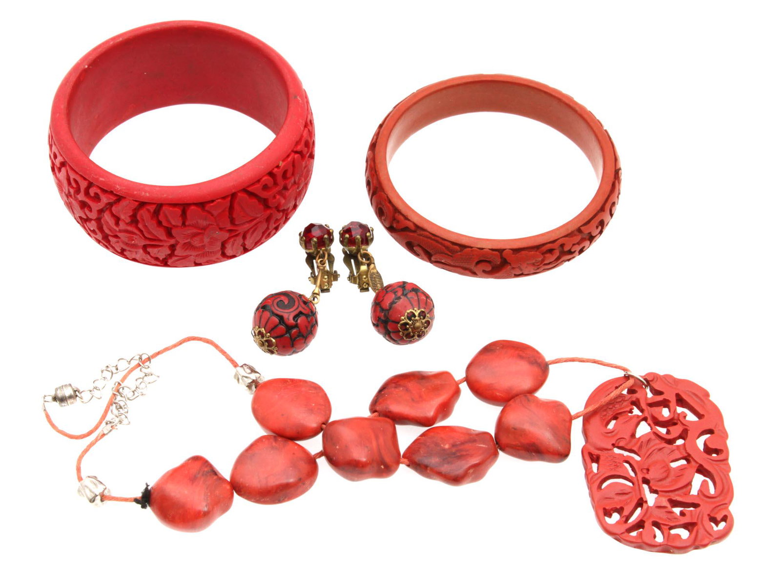 A VINTAGE CHINESE JEWELRY ITEMS FROM RED CINNABAR: A lot of assorted vintage custom jewelry items from Chinese red cinnabar. Included: carved red cinnabar earrings, red cinnabar beads necklace with carved red cinnabar pendant, two red cinnabar bangle 