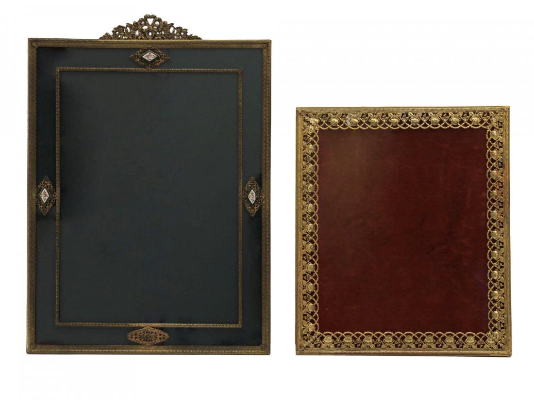 TWO ANTIQUE FRENCH PHOTO FRAMES: Two antique metal frames in the Empire style. The frame with black lining is decorated with diamond-shaped enamel inserts with painted flowers. The frame with burgundy lining is decorated with an open