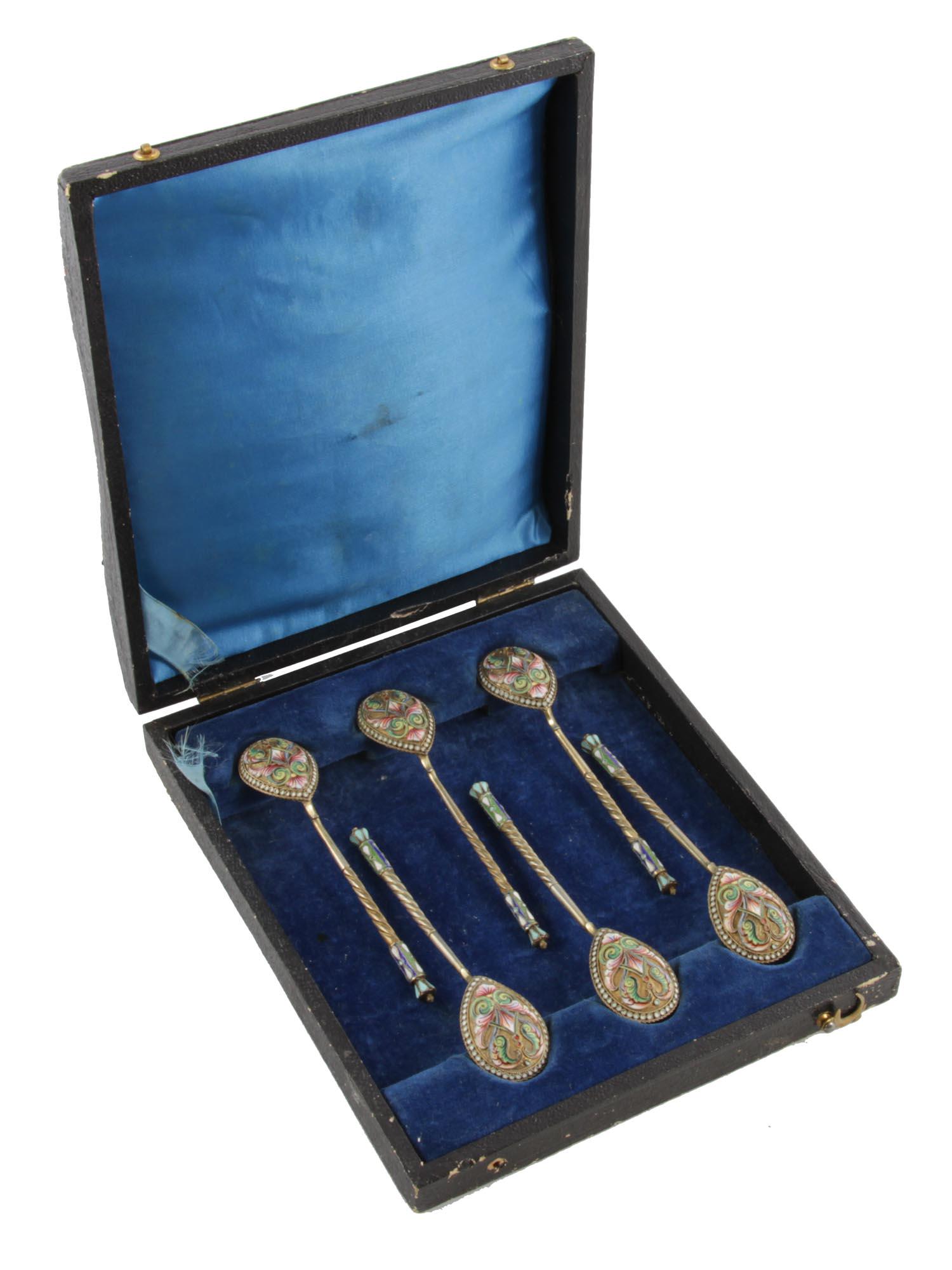 A SET OF SIX RUSSIAN SILVER AND ENAMEL SPOONS: A set of 6 silver-gilt teaspoons with stylized patterns in the neo-Russian style, made using the technique of polychrome cloisonnÃ© enamel, marked on handles: 84 silver standard next to a woman's he