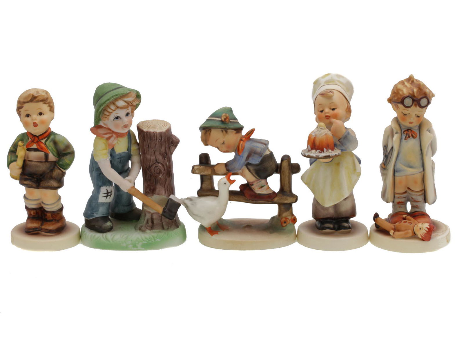 A LOT OF VINTAGE GERMAN HUMMEL GOEBEL PORCELAIN: A set of collectible German ceramic figurines. All figurines, except for the lumberjack boy, are stamped with M.J. Hummel. Some figurines are also marked on the bottom with the blue W. Goebel stamp. D