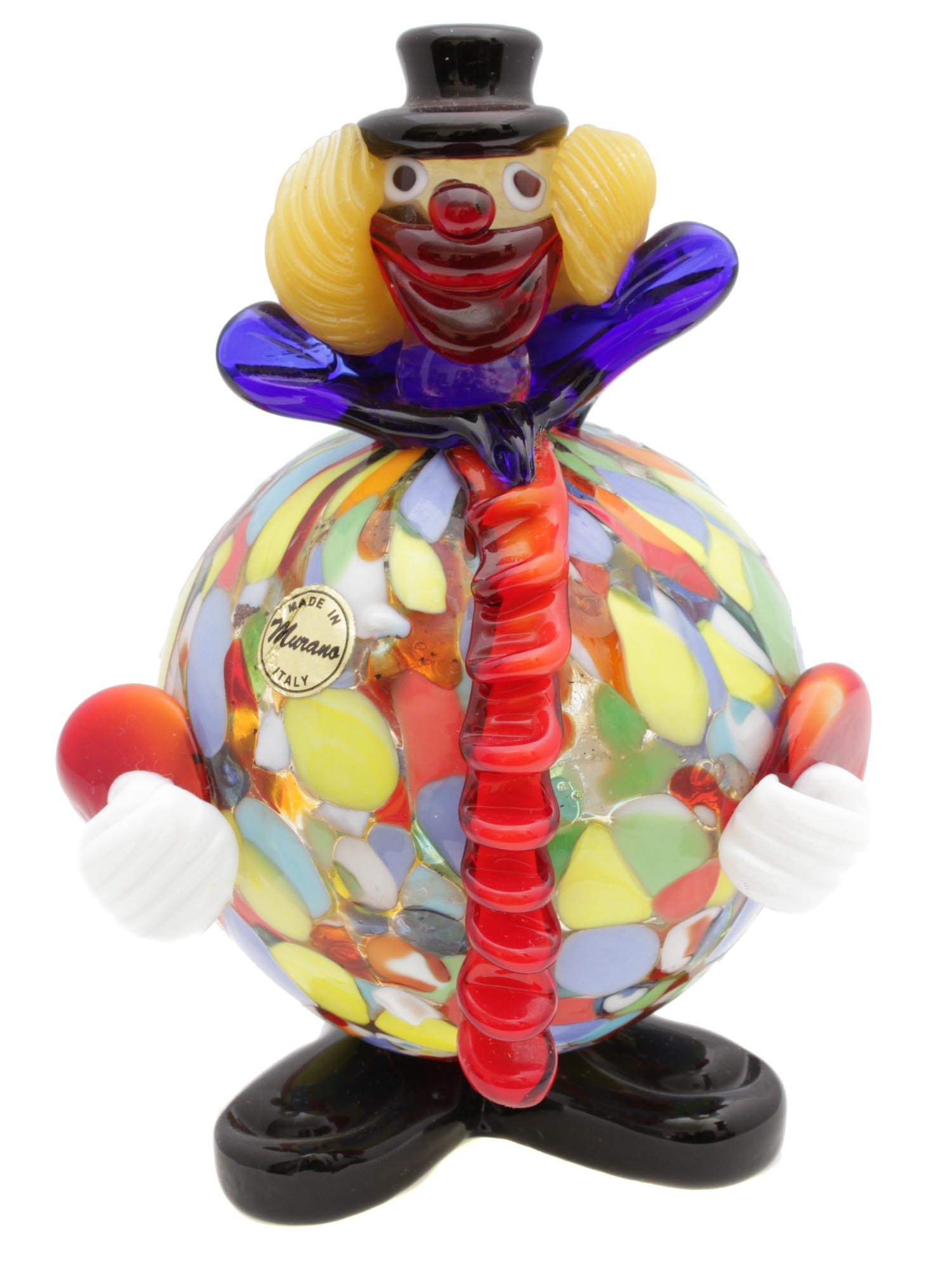 A VINTAGE MURANO GLASS CLOWN FIGURINE: A vintage collectible clown figurine designed by Murano, Italy. The figurine is hand-blown and has elegant shapes and bright colors. With an original Murano Glass sticker. Dimensions: H: 6 in.