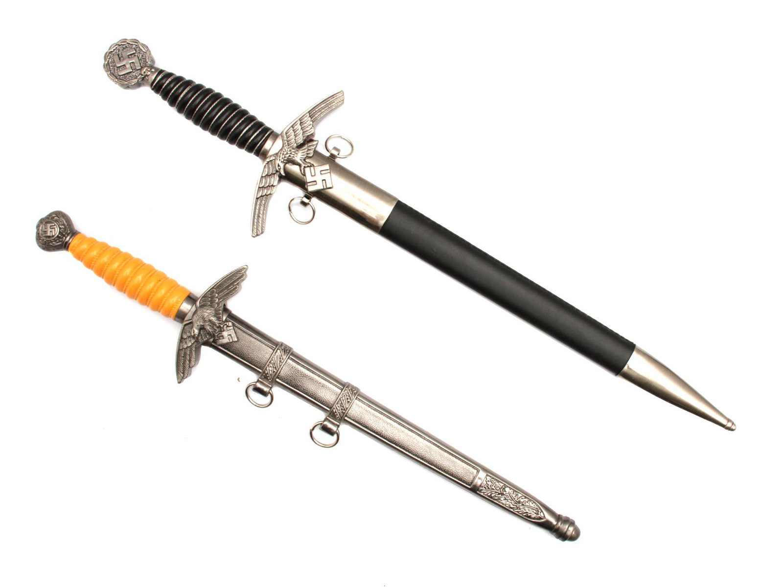 A 2 GERMAN LUFTWAFFE DAGGERS POST WWII PRODUCTION: A lot of two German WWII Luftwaffe daggers, post WWII production. Luftwaffe is a Nazi German Air Force.The first model of Luftwaffe dagger is a dagger with a twisted black plastic handle with a swasti