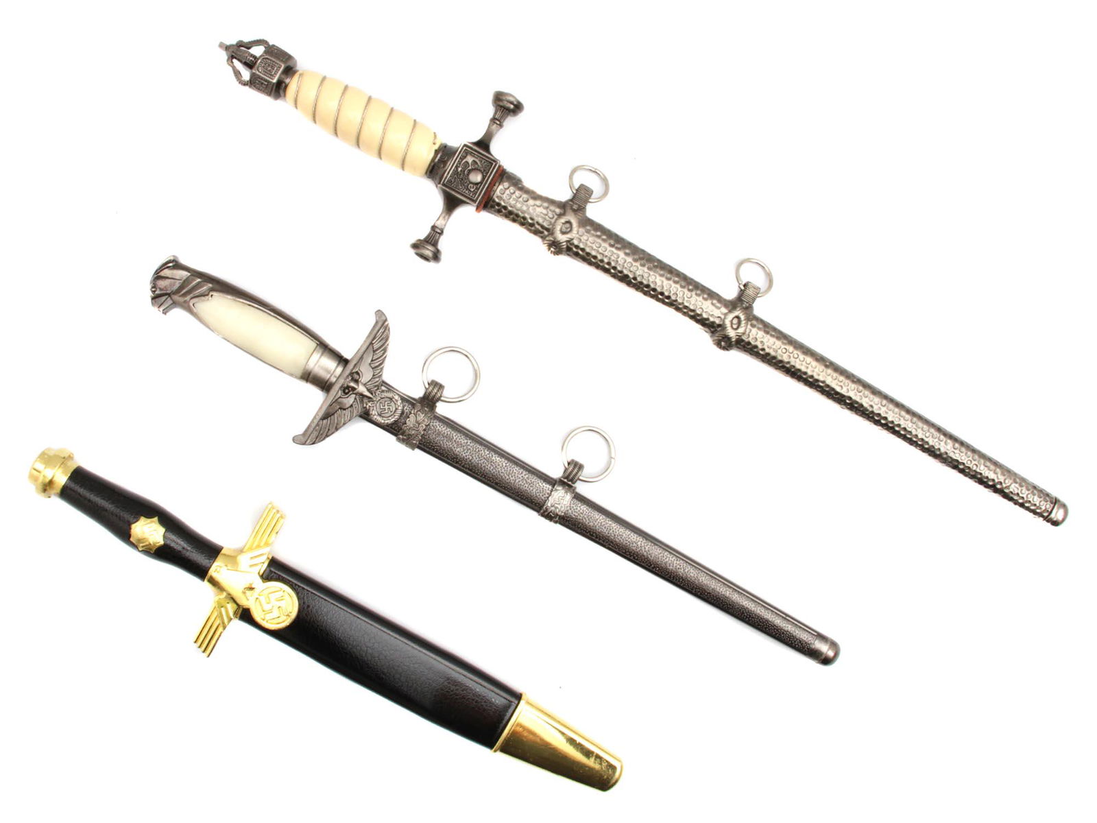 A LOT OF 3 GERMAN DAGGERS POST WWII PRODUCTION: A group of three German daggers, post WWII production.The first one is the German WWII RLB leaderâ€™s dagger. The Reichsluftschutzbund RLB, National Air Raid Protection League - organization in N