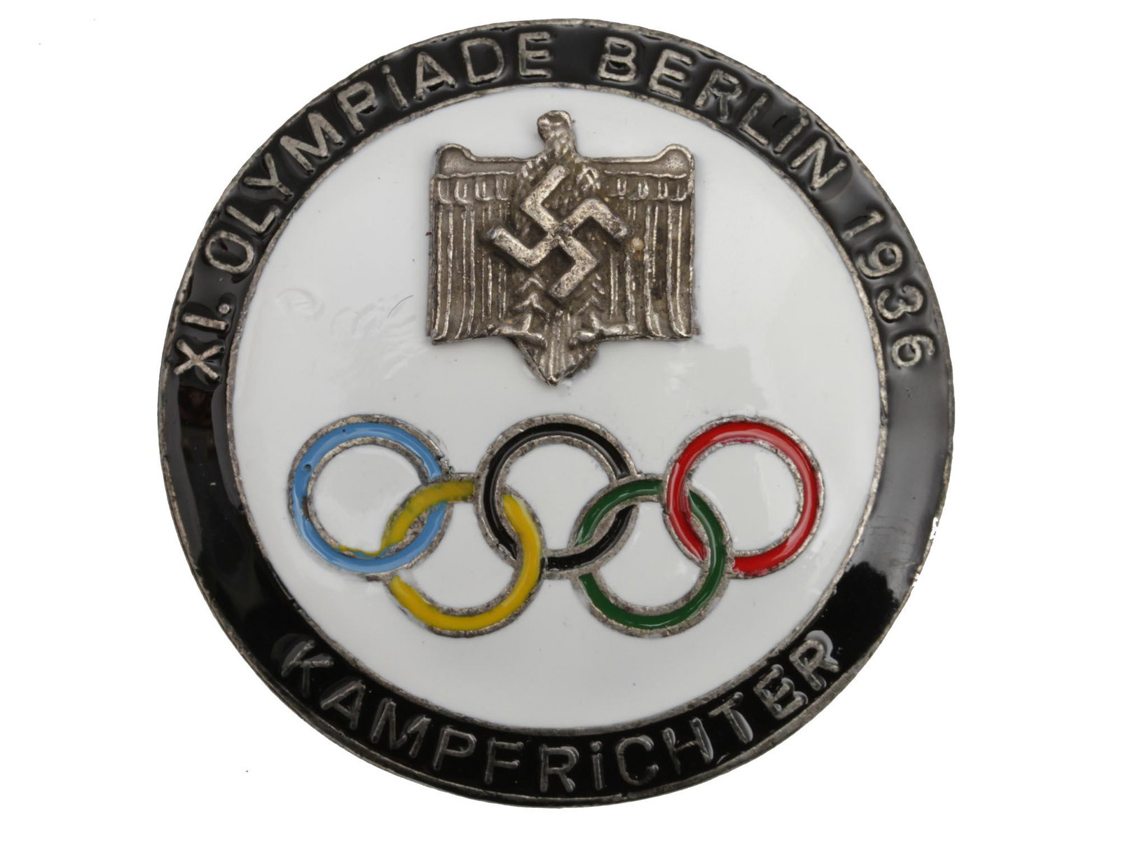 A 1936 GERMAN BERLIN OLYMPIC KAMPFRICHTER BADGE: A German Berlin 1936 Olympic Games Richter Kampfrichter badge. The badge obverse with a Nazi swastika rune is enameled in white color, with five Olympic rings and a black enameled border with an inscr