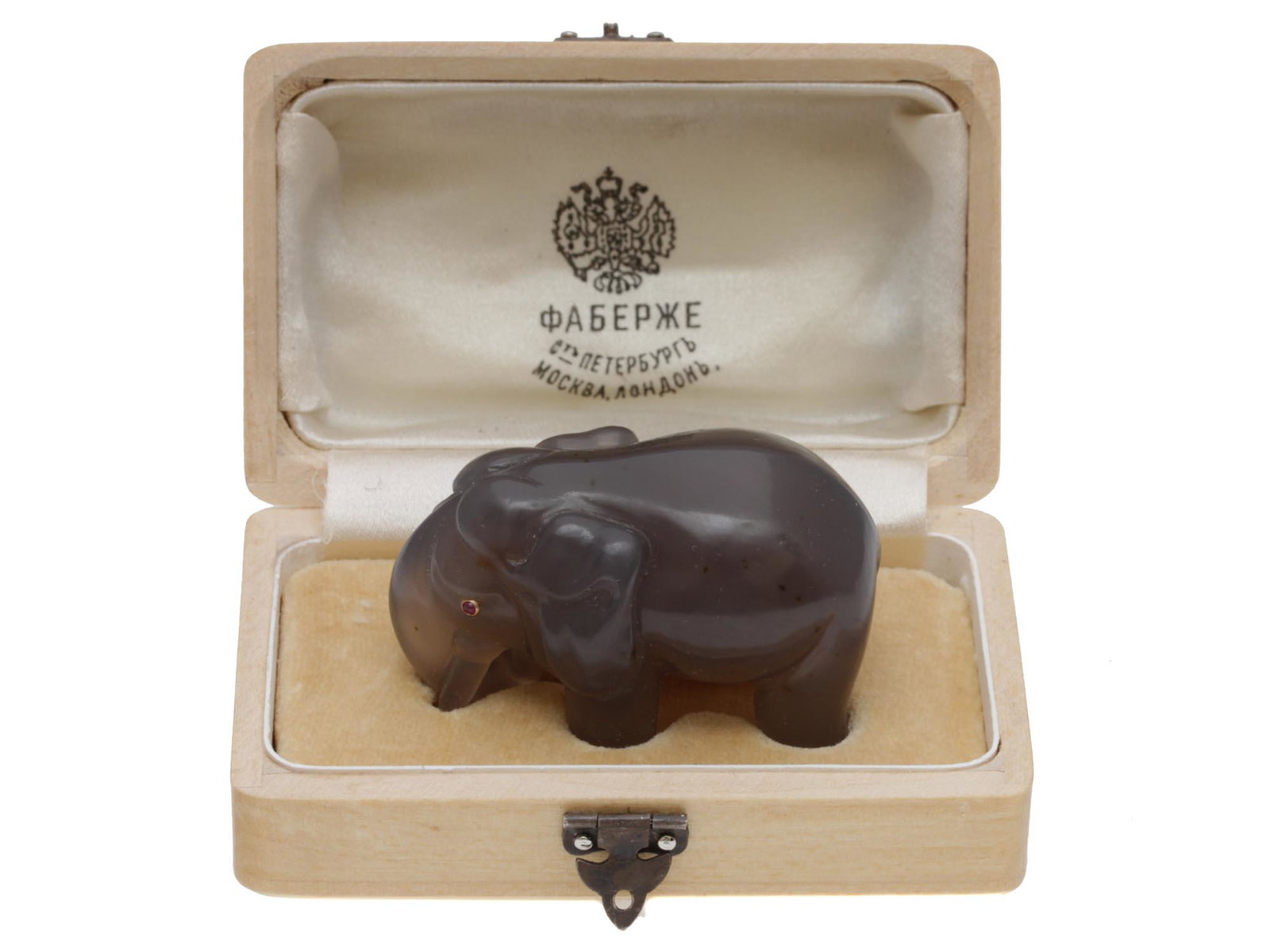 A RUSSIAN AGATE CARVED ELEPHANT FIGURINE: A Russian gorgeous naturally carved agate stone elephant figurine with inlaid ruby burgundy stone eyes in a gold setting. Complete with a wooden box with a protector inside for the figurine safety. Di