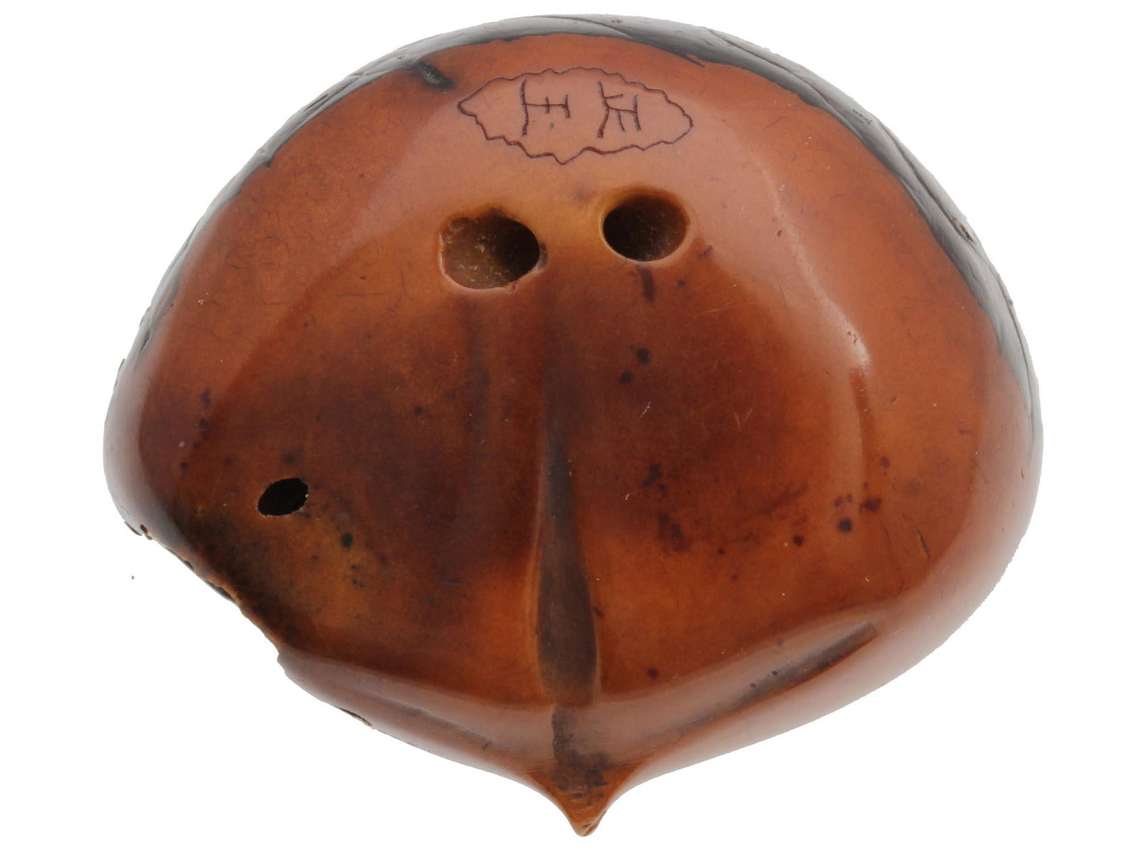 AN ANTIQUE JAPANESE CARVED WOOD NETSUKE: Fine Japanese Meiji period netsuke hand-carved from wood with the figure of chestnut (kuri). With two holes for using rope to hang the item. Has a beautifully polished surface with a carved hieroglyph