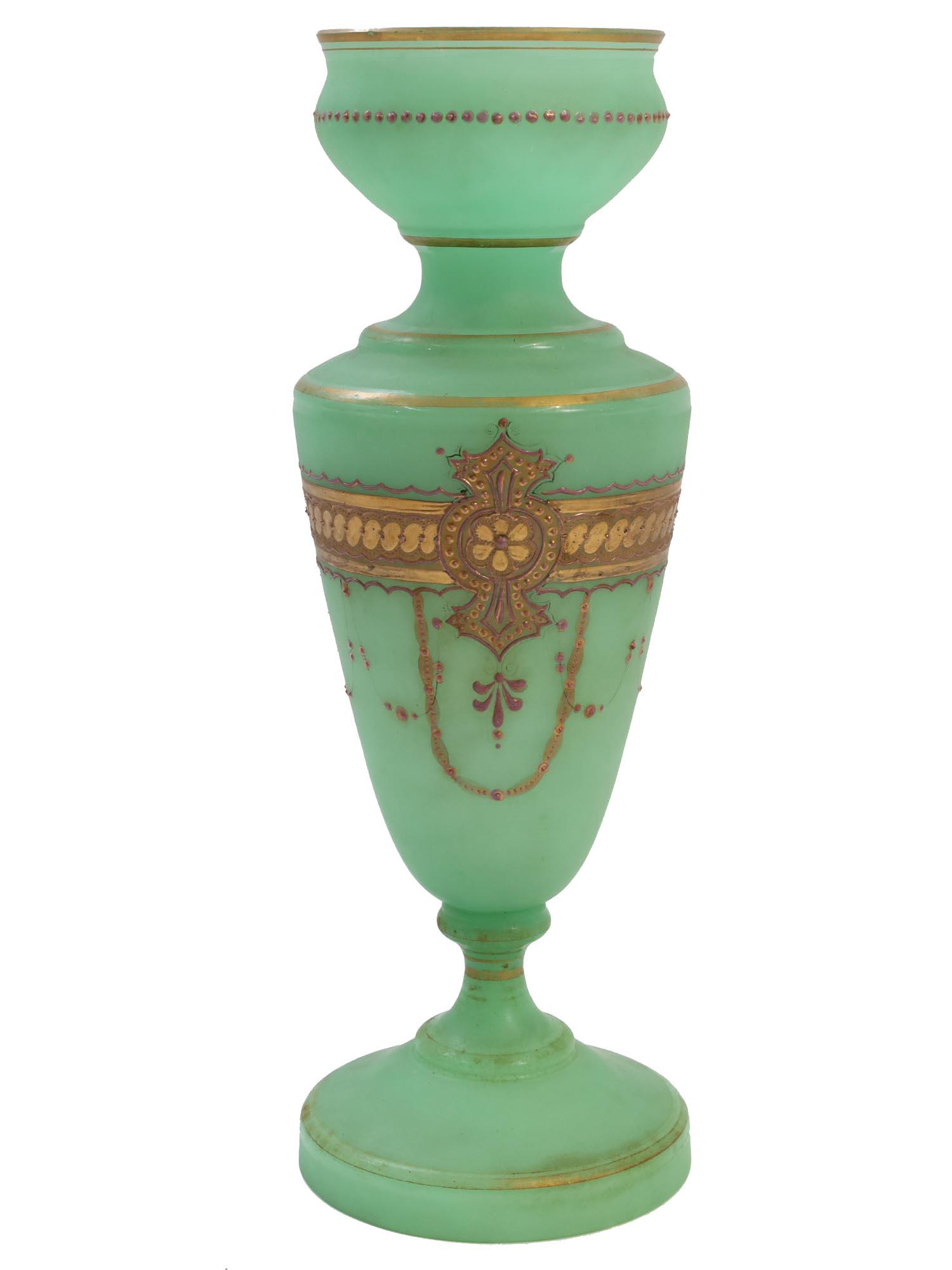 AN ANTIQUE FRENCH OPALINE GREEN GLASS VASE FLORAL: An Antique French opaline green glass vase in footed amphora shape decorated with floral gilding. Circa early 19th century. Slight scuffs at the base. Dimensions: H: 13 3/4 in., (35 cm.)