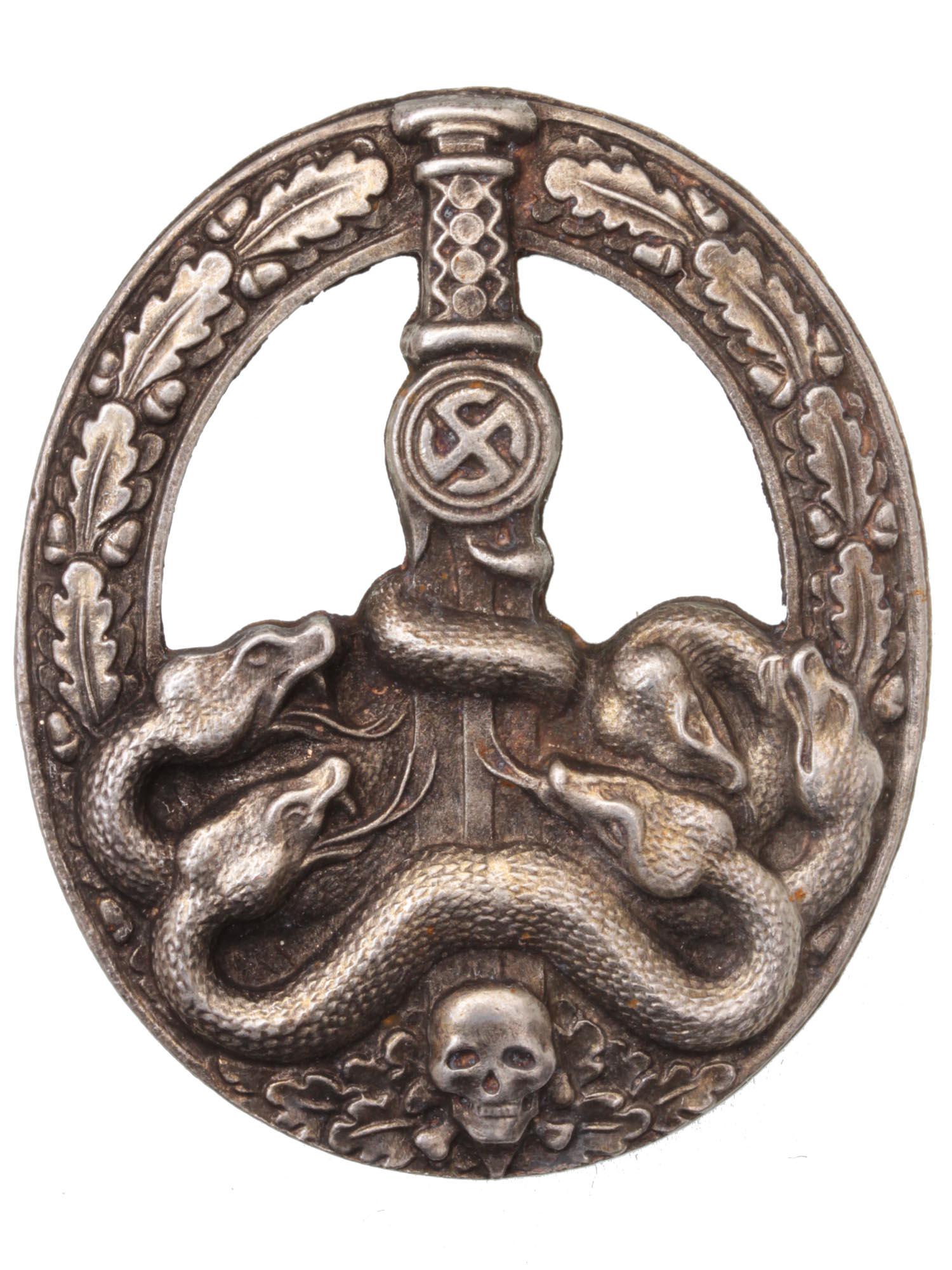 A GERMAN WWII THIRD REICH ANTI PARTISAN BADGE: This is a German WWII Army Heer Anti Partisan Badge. The front shows six snakes on the lower part wrapped around a sword blade with a skull at the base, surrounded by an oval oak leaf wreath. It has a