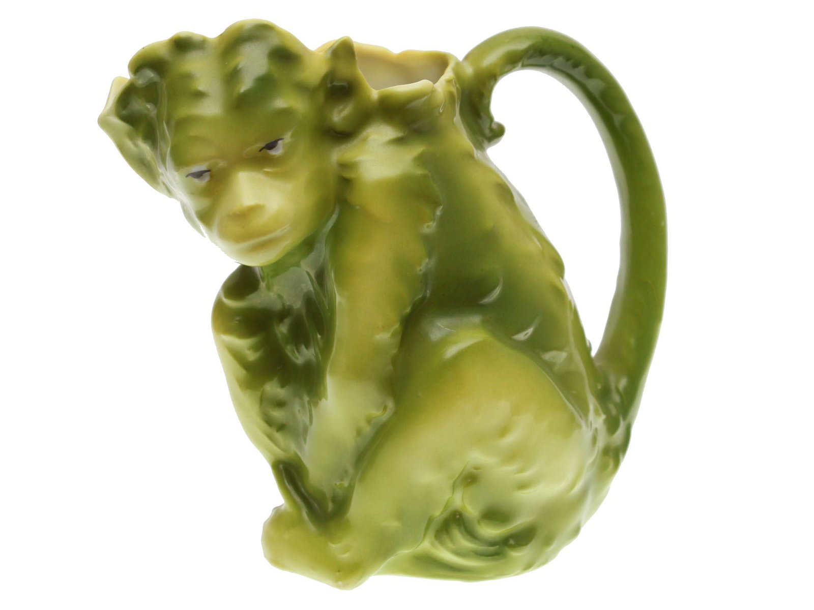 A ROYAL BAYREUTH PORCELAIN MONKEY CREAMER: A vintage Bavarian Royal Bayreuth porcelain creamer in the form of a monkey figurine in a light green color. Marked in blue, Royal Bayreuth Bavaria, on the bottom. Circa: the early 20th century. Dimen