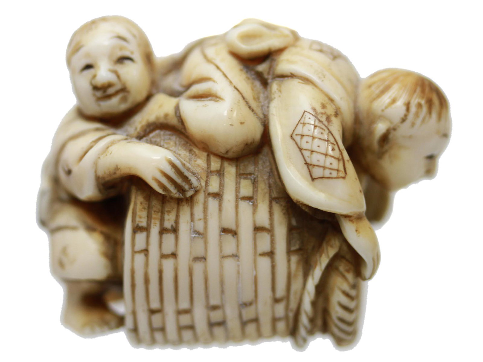 ANTIQUE HANDCARVED JAPANESE NETSUKE CHILDREN CASK: An antique Japanese hand-carved from natural materials netsuke, depicting children crawling on barrel. There are two cord holes on the barrel. Circa mid-late 19th century. Marked on the barrel. Dimens