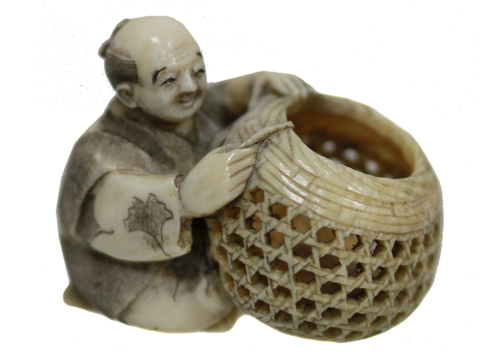 ANTIQUE HAND CARVED JAPANESE NETSUKE MAN W BASKET: An antique Japanese hand-carved, engraved, inked from natural materials netsuke, depicting an old man holding a mesh basket. There are two cord holes on the back. Marked on the bottom. Circa mid-late