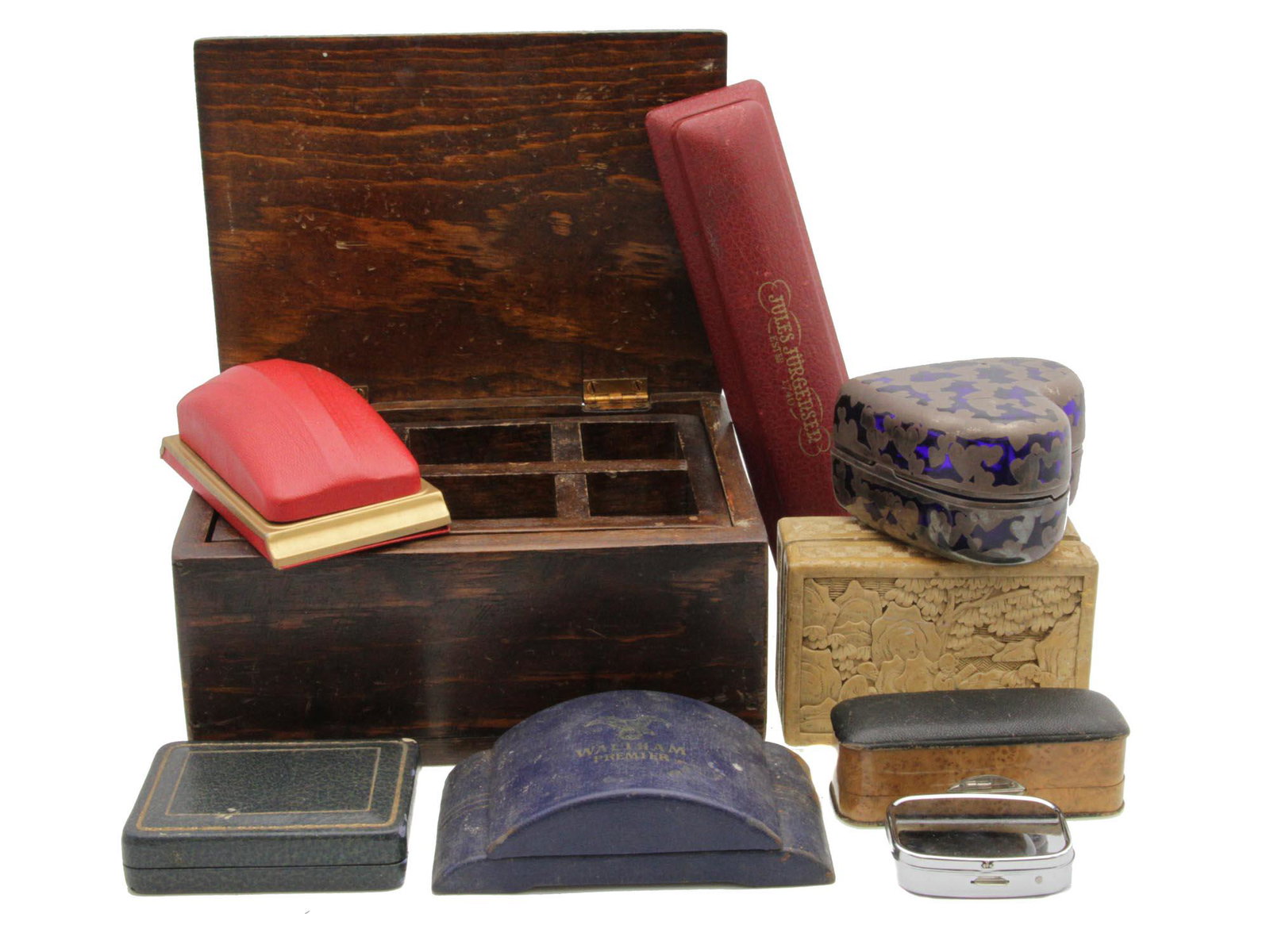 A SET OF NINE VINTAGE WATCH AND JEWELRY BOXES: The lot includes: a wooden box with various compartments for jewelry or wristwatches, a carved vintage Chinese box, a wristwatch box from Jules Jurgensen, a wristwatch box from Waltham Premier, and ot