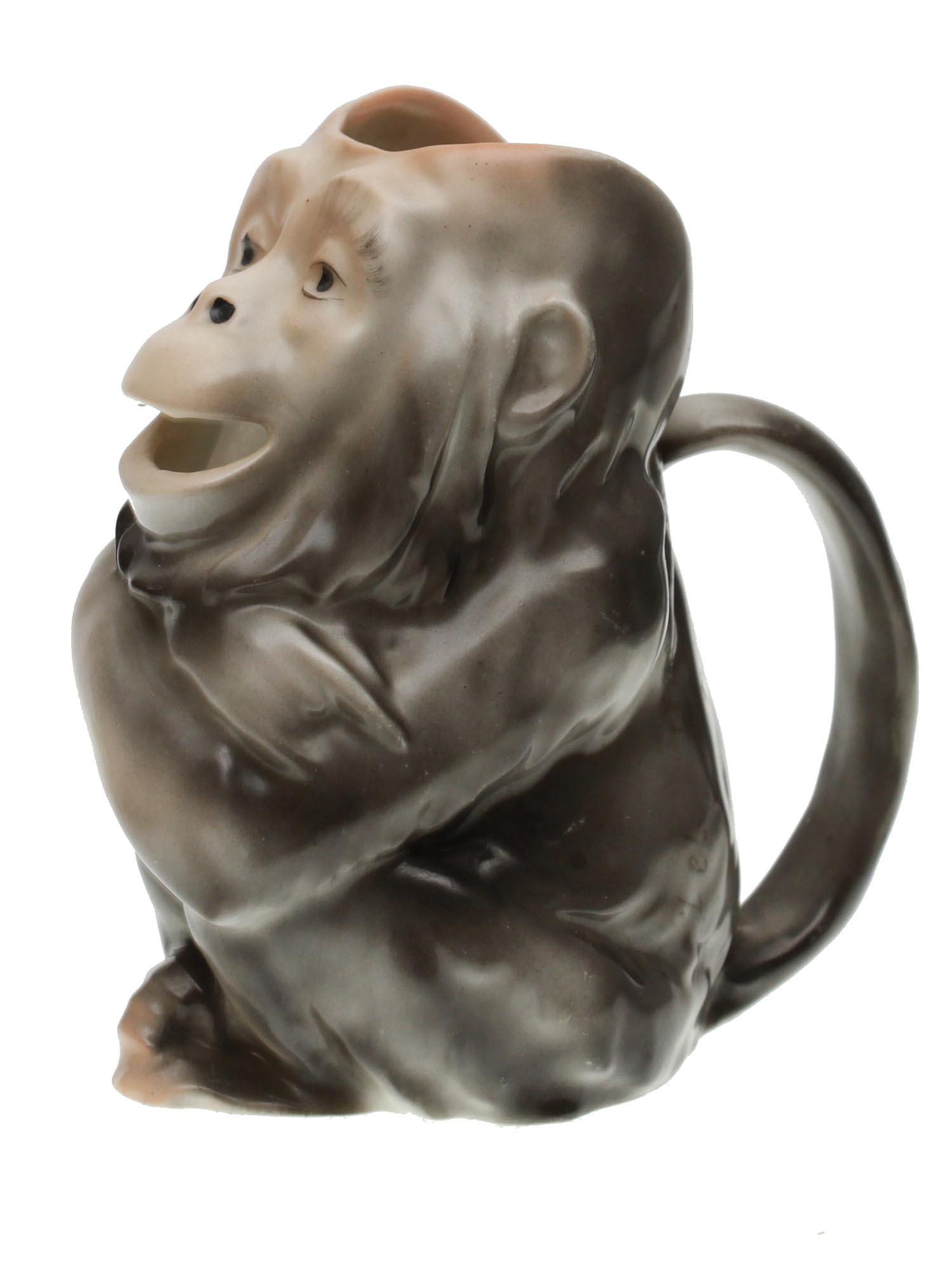 A BAVARIAN ROYAL BAYREUTH PORCELAIN CHIMP CREAMER: A vintage Bavarian Royal Bayreuth porcelain creamer in the form of a sitting chimp figurine in grey color. Decorated with a semicircular handle. Marked in blue, Royal Bayreuth Bavaria, and, 28, on the