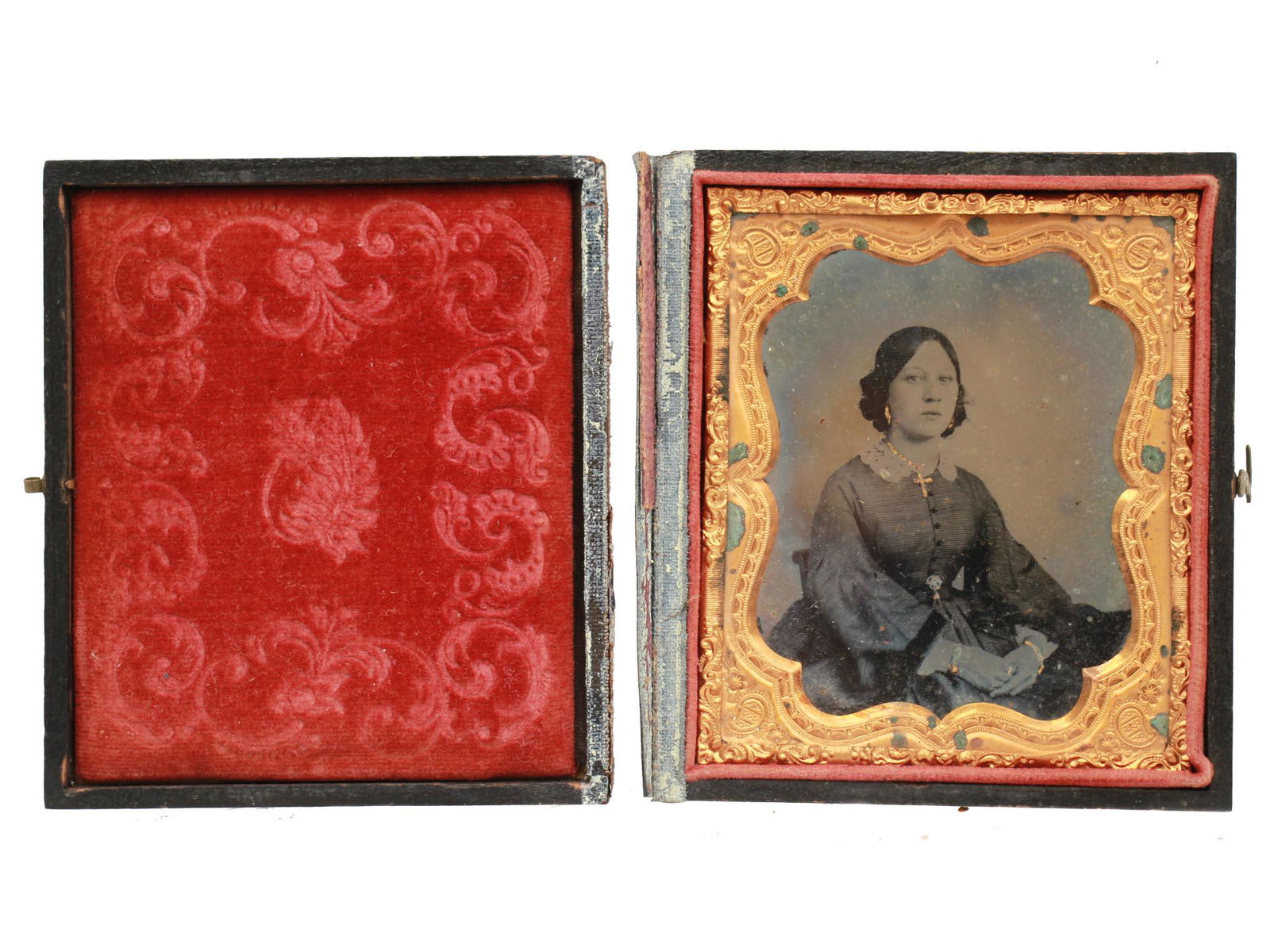 AN ANTIQUE AMERICAN TINTYPE PHOTOGRAPH PORTRAIT: An original 19th-century American tintype portrait of a young lady in an original thermoplastic case with a brass fastener and red velvet linen. Dimensions: 3 1/2 X 3 in.