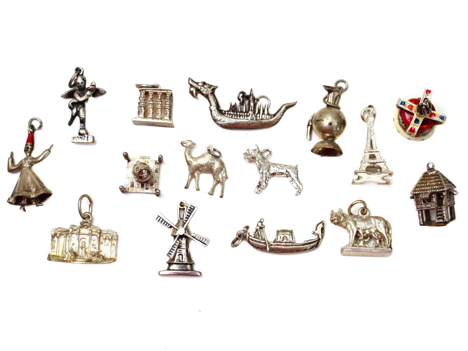 A LOT OF FIFTEEN COLLECTION SILVER CHARMS: A lot of fifteen collection travel theme silver charms in the forms of various sights of Italy, France, China, Netherland including Eiffel Tower, Capitoline wolf feeding Romulus and Remus, Venetian go