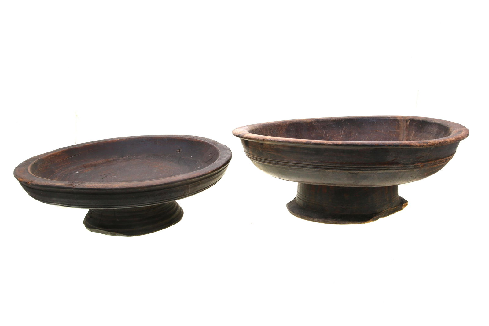 A PAIR OF TURKMEN WOODEN FRUIT CANDY TABLE TRAYS: A pair of Turkmen hand-made wooden fruit or candy table trays on round-shaped legs. Unmarked. Dimensions: Smaller: D 11 7/8" in, H 4" in Larger: D 12 3/4" in, H 4 1/2" in