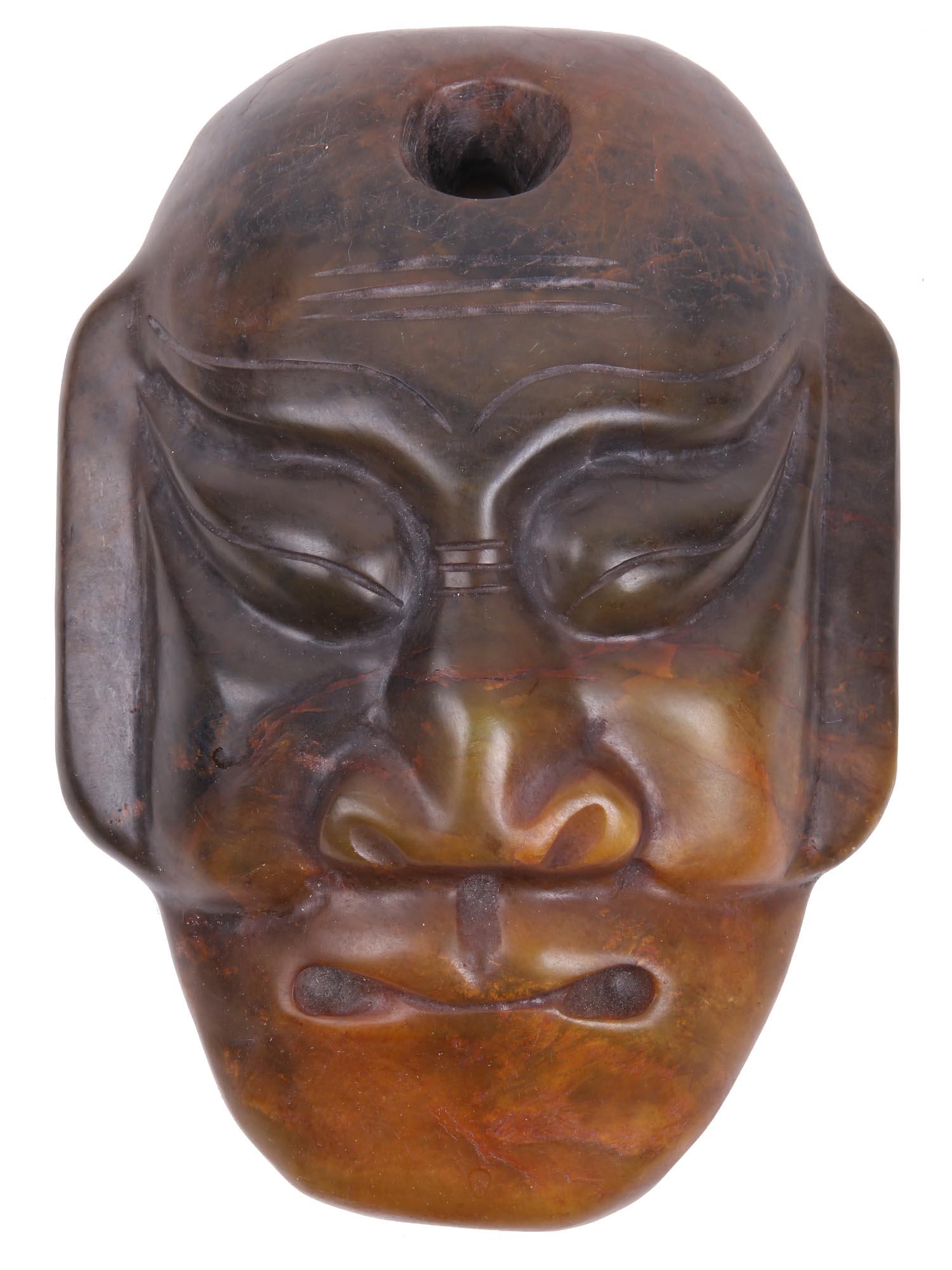 LATE 19TH CENTURY ASIAN HAND CARVED JADE MASK: A late 19th-century Asian hand-carved and polished jade mask with a hole on the top. Probably, the mask was used in Noh theater. Dimensions: 7 1/4" x 5 1/8" x 1 5/8" InAll measurements are approximate