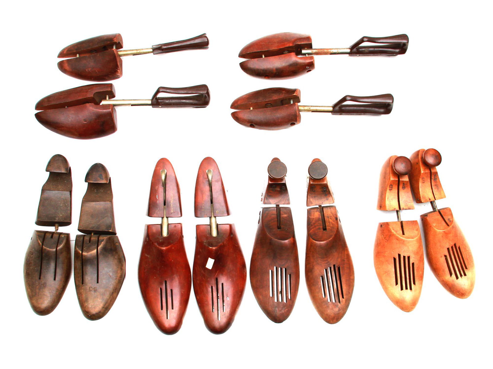 A COLLECTION OF VINTAGE WOODEN SHOE TREES WEBER: A collection of six pairs of vintage designer wooden shoe trees with metal heels in various sizes, types, colors. Made by various manufacturers, one marked, Weber and Heilbroner, etc. Dimensions: Smal