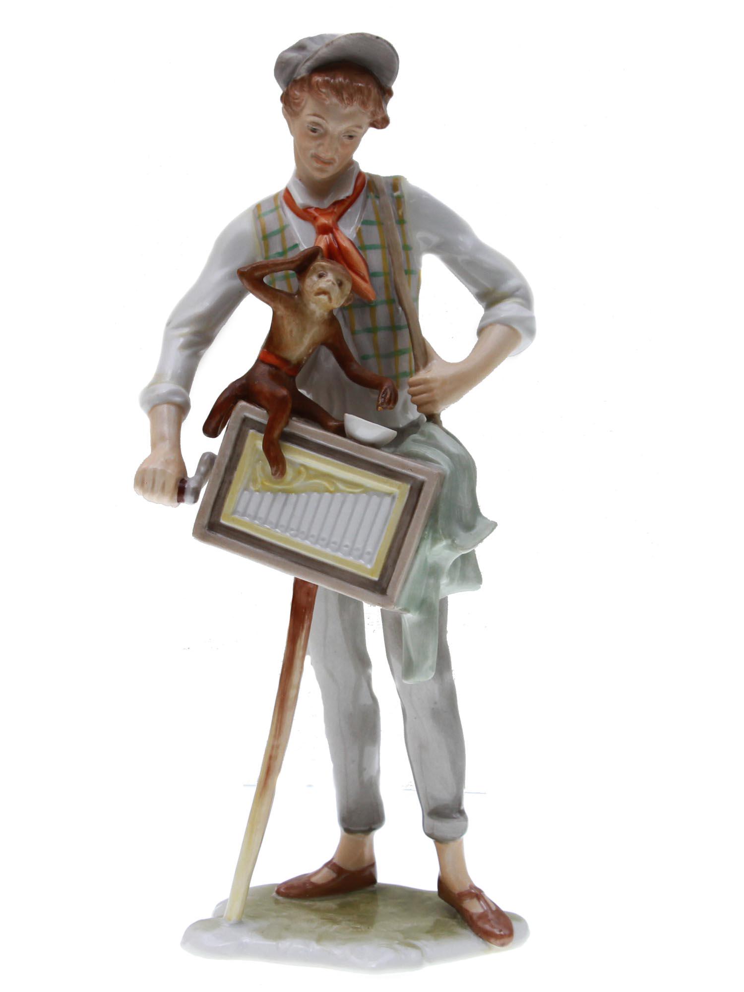A VINTAGE ALKA KUNST BAVARIAN PORCELAIN FIGURINE: Hand-painted porcelain figurine, made in Bavaria by Alka Kunst and depicting an organ grinder with a monkey, possibly a character from a German fairy tale. Marked on the base with the manufacturer's g