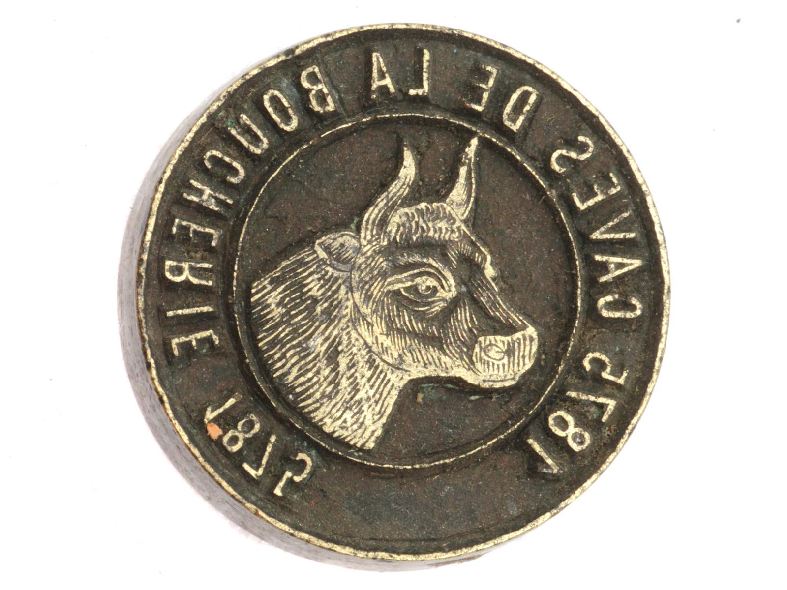 AN ANTIQUE FRENCH CAVES DE LA BOUCHERIE SEAL: An antique metal seal with a picture of a cow and a mirrored inscription: 1875 CAVES DE LA BOUCHERIE 1875. Dimensions: D: 1 3/8 in.