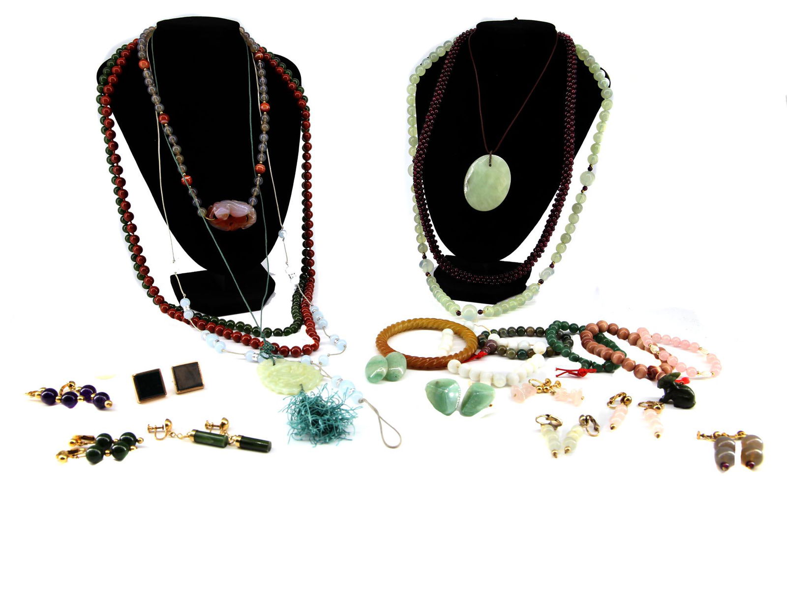 A LOT OF JADE NEPHRITE AVENTURINE GARNET JEWELRY: A lot of Mid century various jewelry including necklaces, bracelets, pendants, and earrings. All items are made of natural stones: aventurine, nephrite, jadeite, quartz, garnet. The jade pendant is ma