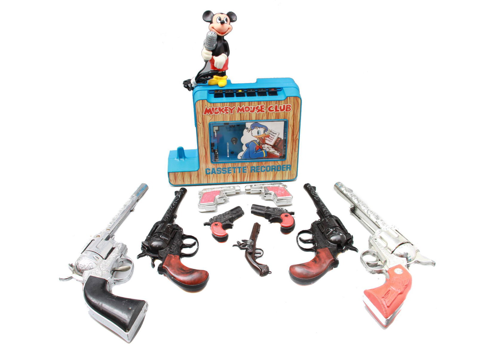 MICKEY MOUSE CASSETEE RECORDER AND TOY GUNS: Mickey Mouse Club portable plastic cassette recorder with Mikey's microphone. Model no. 4905. Made in Hong Kong. In the original box. Various plastic toy guns, revolvers, and pistols without package o