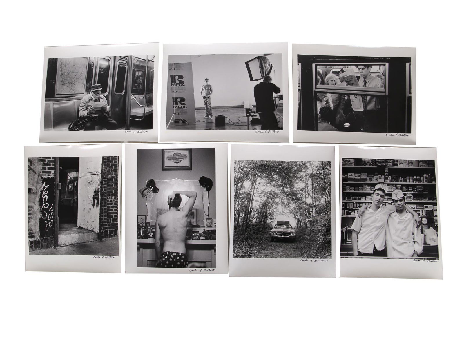 SEVEN ANALOGUE PHOTOS BY NYC ARTIST CARLOS GUSTAVO: A set of seven analog black and white gelatin silver print on fiber paper photo prints by Carlos A. Gustavo. All signed by the photographer. Some with the notes on verso. Carlos A. Gustavo was a very