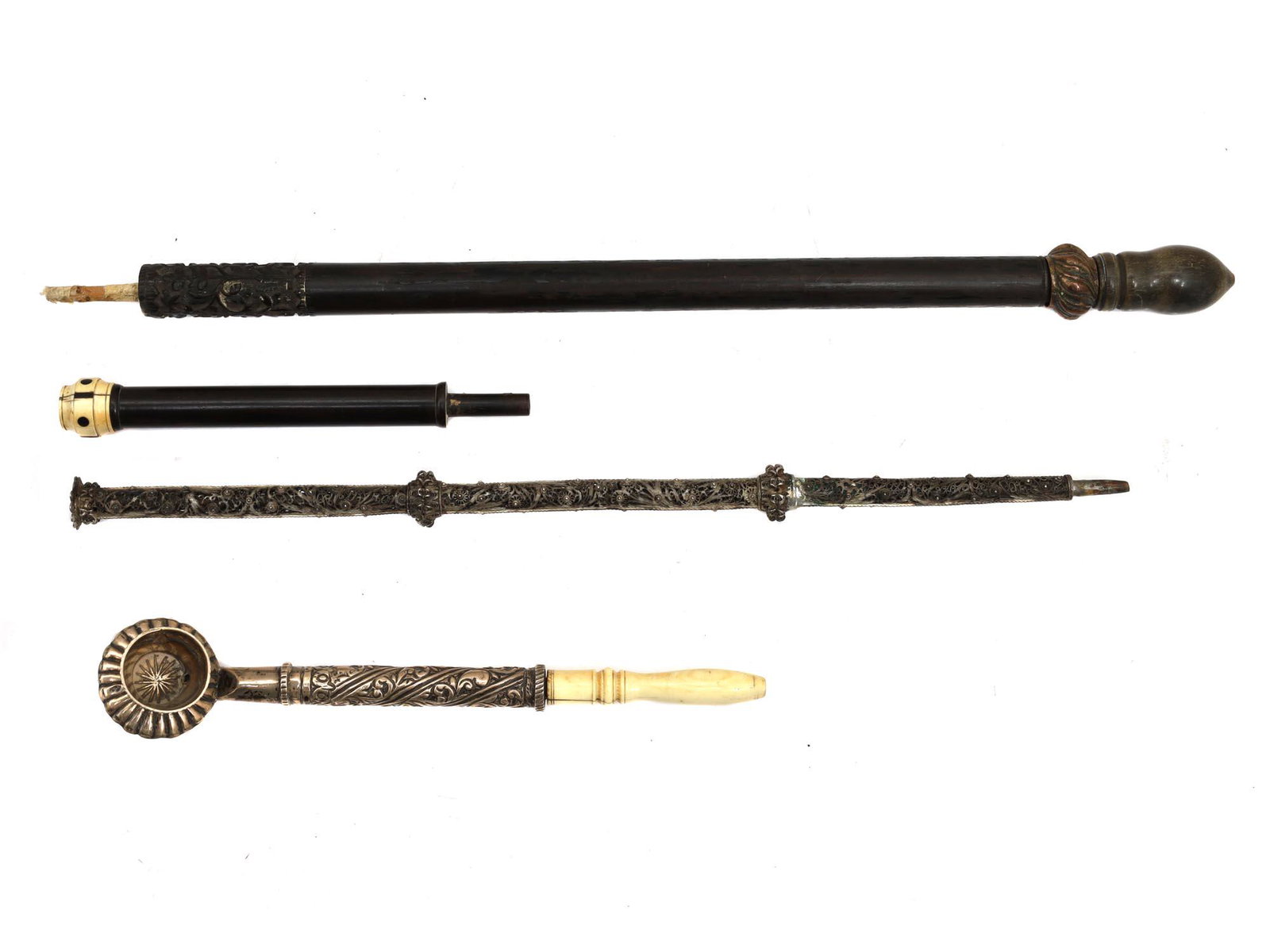 A SET OF SILVER-MOUNTED TURKISH SMOKING PIPES: A set of 19th-century Turkish smoking pipes, including a large Ottoman wooden chibouk pipe, an openwork silver pipe decorated with filigree, and a silver pipe with a carved bone handle. Dimensions: L: