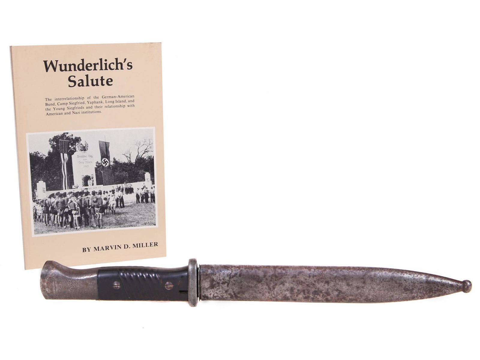 SET OF ORIGINAL BAYONET SWORD AND BOOK BY MILLER: A set of two vintage items. The first: an original Bayonet one-blade metal sword with a leather-wrapped handle and a scabbard with a blunt end. Numbered on a ricasso. The second: a book, Wunderlich's 