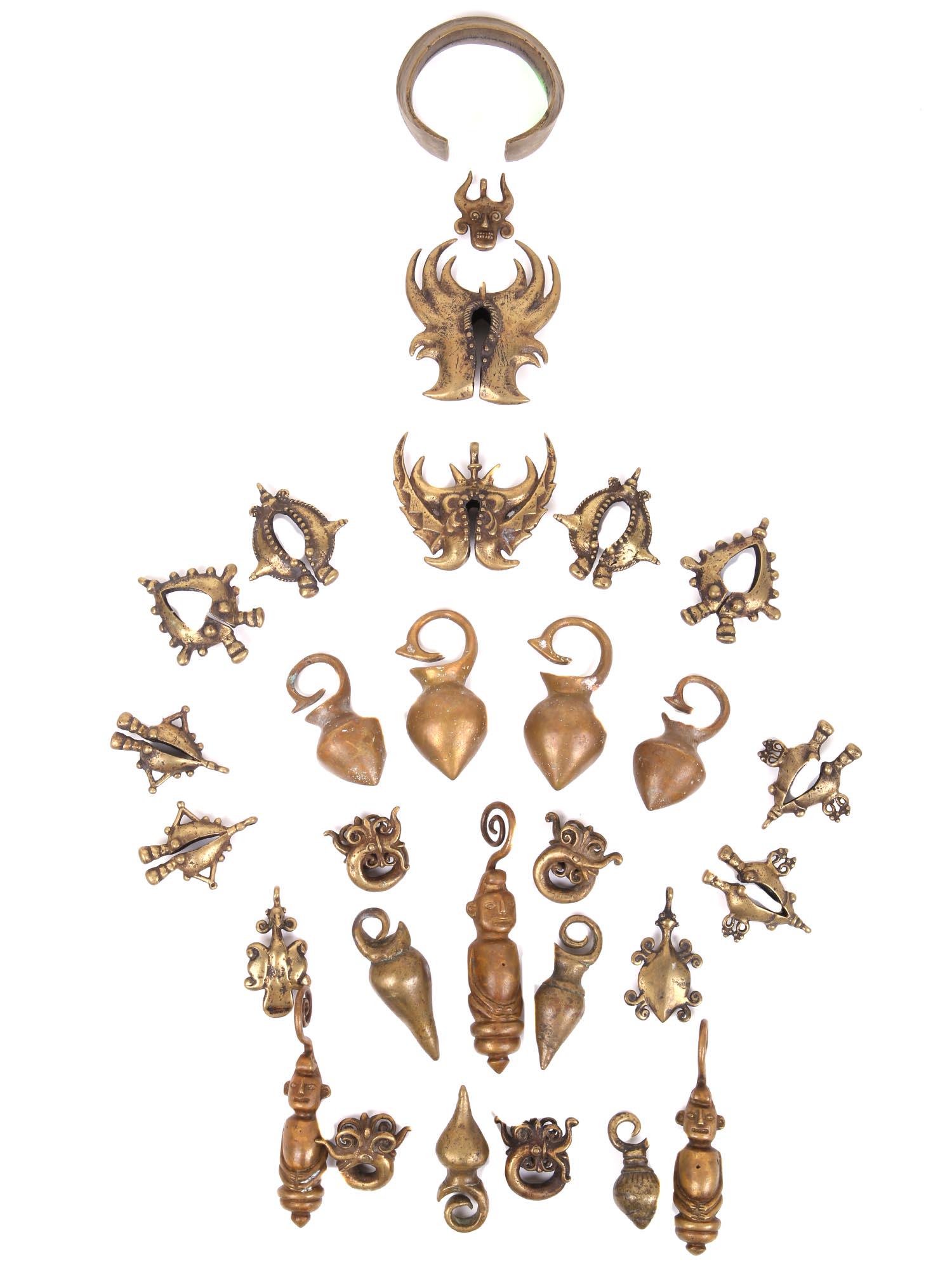 A COLLECTION OF INDONESIAN ETHNIC BRASS CHARMS (1 of 9)