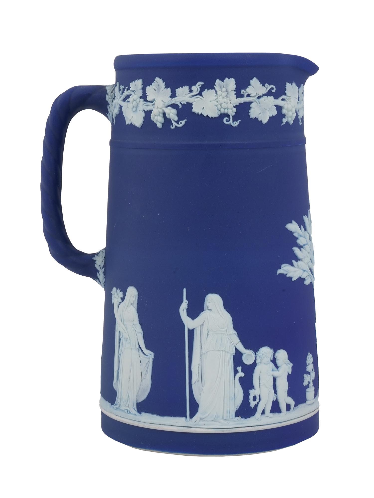 ANTIQUE WEDGWOOD COBALT BLUE JASPERWARE JUG: Antique British Neoclassical style Finely decorated with intertwining scrolls and panels with figures cobalt blue jasperware jug. Finely decorated with female figures with children, cherubs, animals, 