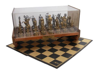 VINTAGE NAPOLEON CHESS SET GRAND MASTERS AWARD: A vintage Classic Games chess set featuring Napoleon Bonaparte's army in gold and silver tones, circa 1970. Complete with a wood stand and glass cover, a brass plaque signed: Grad Masters Award, Dave