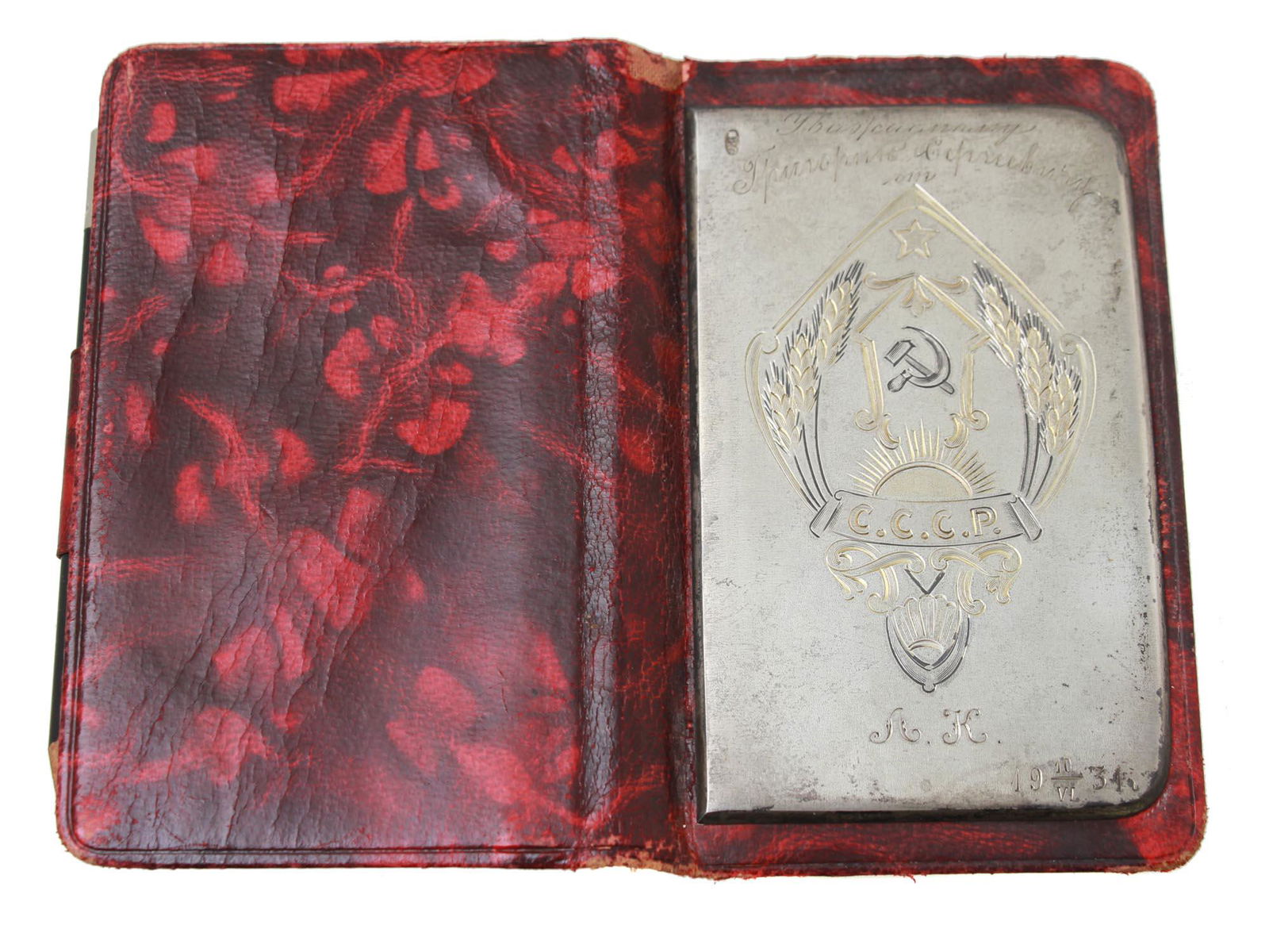 VINTAGE 1931 RUSSIAN SILVER PATRIOTIC PAD: A Russian, Soviet, 1931 patriotic pad in a red leather wrapper with a silver plate decorated with gilding and engraved with a coat of arms of the USSR with hammer and sickle and inscription in the Cyr