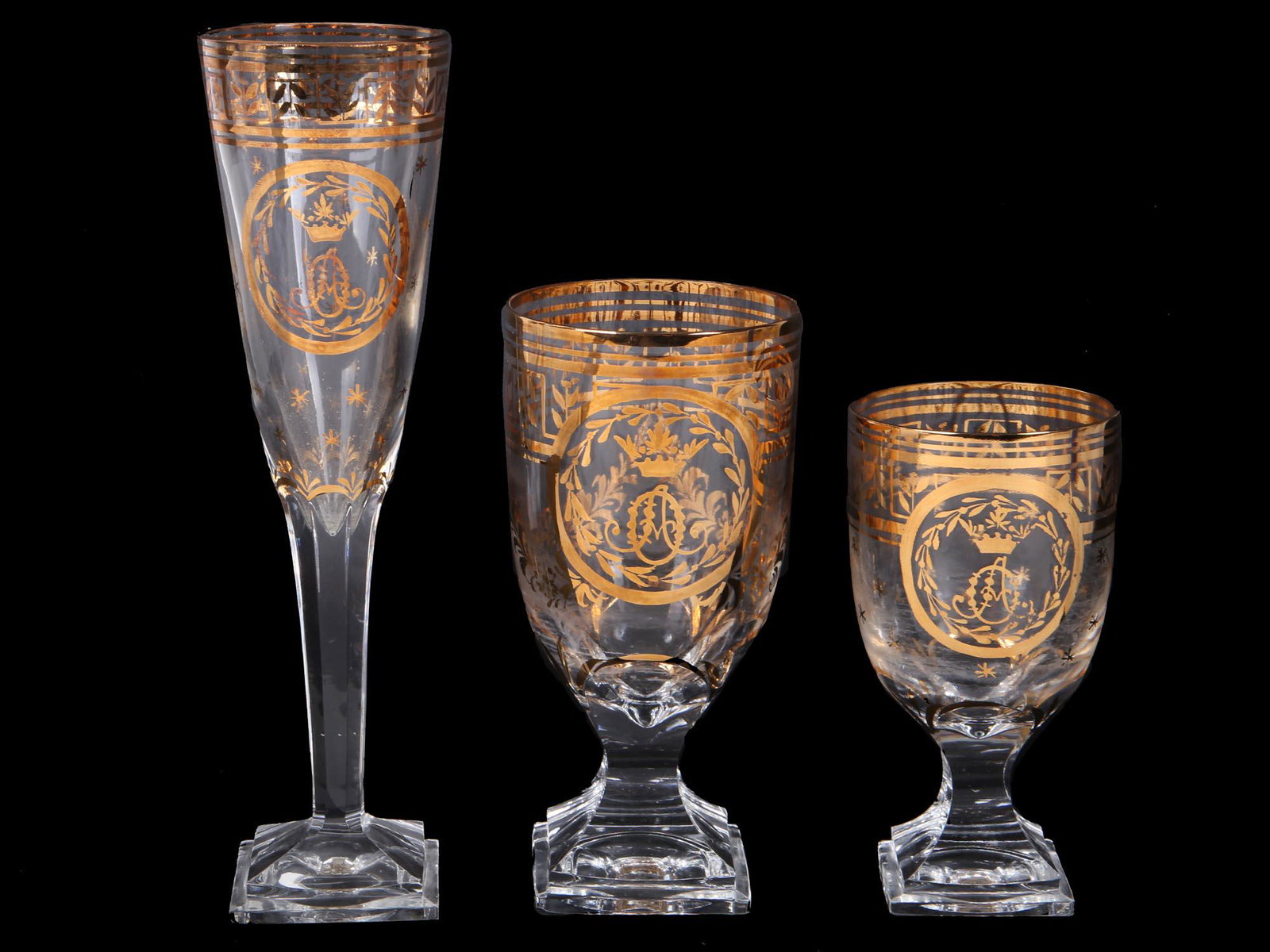 ANTIQUE RUSSIAN WINE GLASSES IMPERIAL FACTORY: Three antique Russian wine glasses of various sizes. Russian Imperial Factory, late 19th century. Elongated form with a square base, each glass has exquisite gilded ornament, and Grand Duchess Olga Al