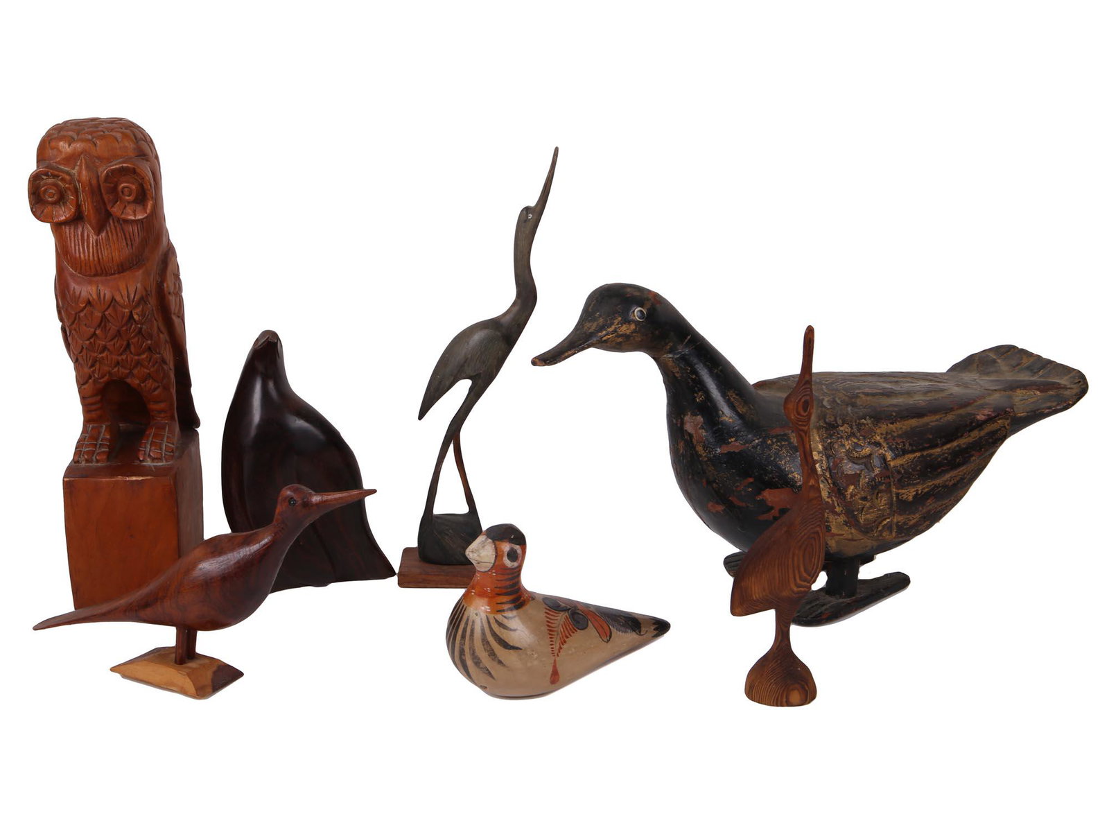 VINTAGE CARVED WOODEN BIRD SCULPTURE COLLECTION: A collection of seven carved wooden bird sculptures including the figurines of an owl, a duck, a crane and others. Some are decorated with paintings. Home decor collectibles. Dimensions: Biggest 8 1/2