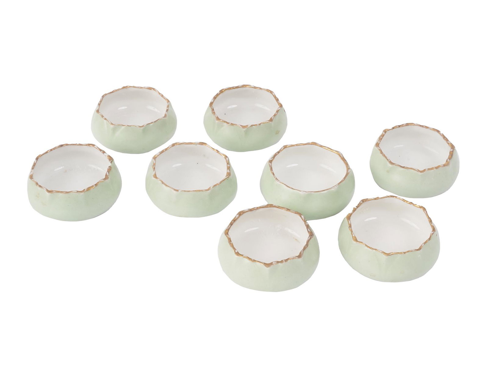 EIGHT FRENCH BC SMALL PORCELAIN SALT CELLARS SET: A set of eight vintage French B and C small porcelain salt cellars. The salt cellars are covered with a glaze in a light green shade and gilded scalloped rims. Each cellar is marked with a green manuf