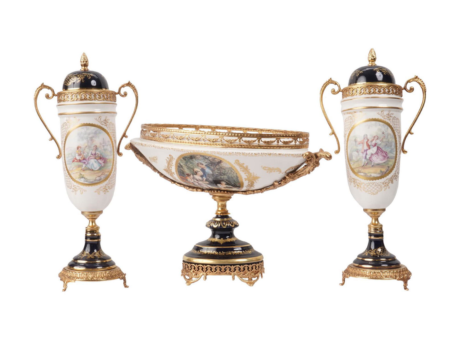VINTAGE FRENCH LIMOGES PORCELAIN VASES FRUIT BOWL: A three piece vintage French Limoges porcelain garniture including two lidded pedestal vases with gilt swan neck handles, featured gilt rims and matching central oval jardinieres hand painted with cla