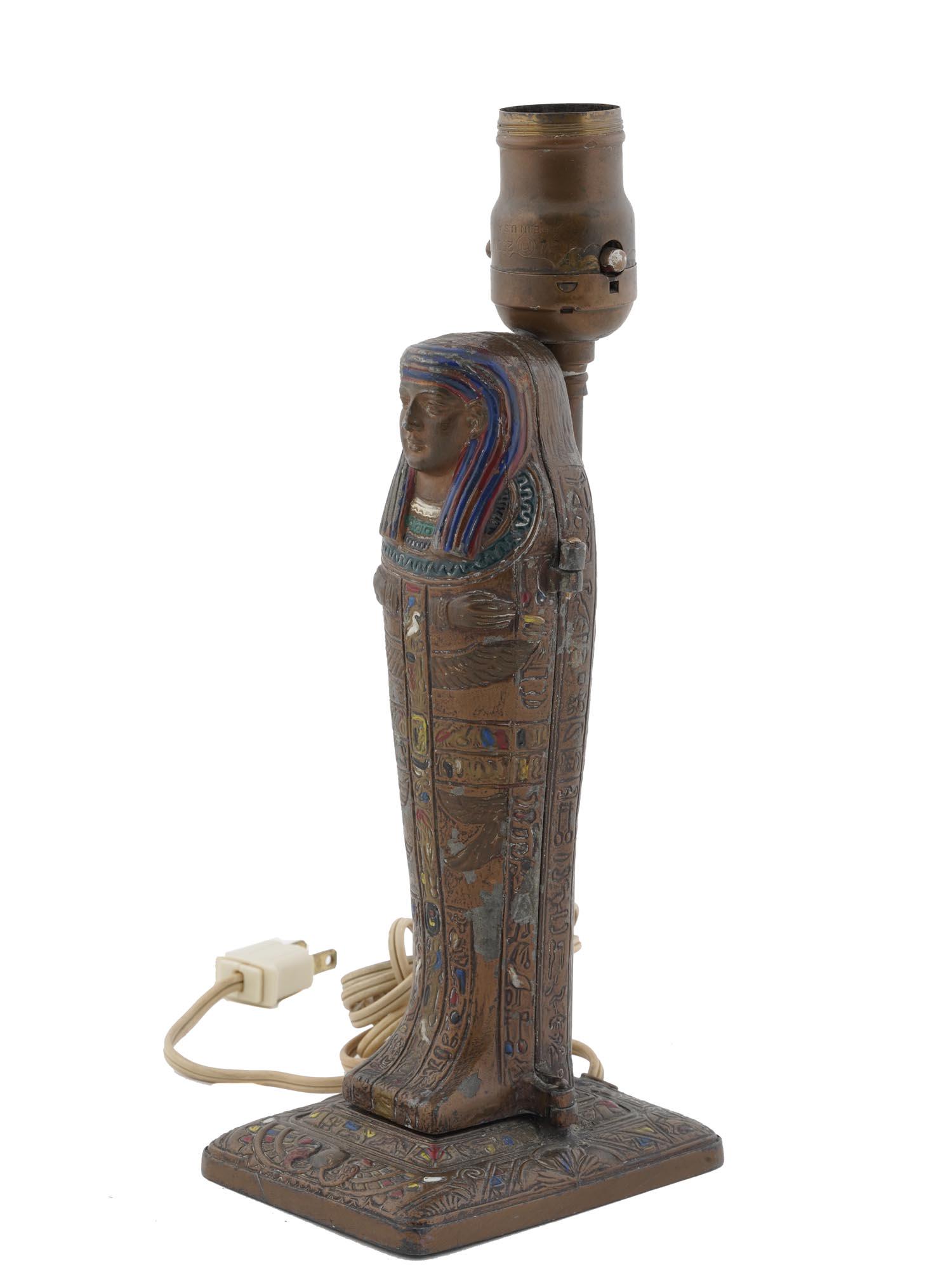 ANTIQUE ART DECO EGYPTIAN MUMMY LAMP BY ARONSON: An antique 1923 Art Deco table lamp manufactured by L.V. Aronson's Art Metal Works in Newark, New Jersey. The lamp is made of spelter metal and executed in the form of a mummy sarcophagus covered with