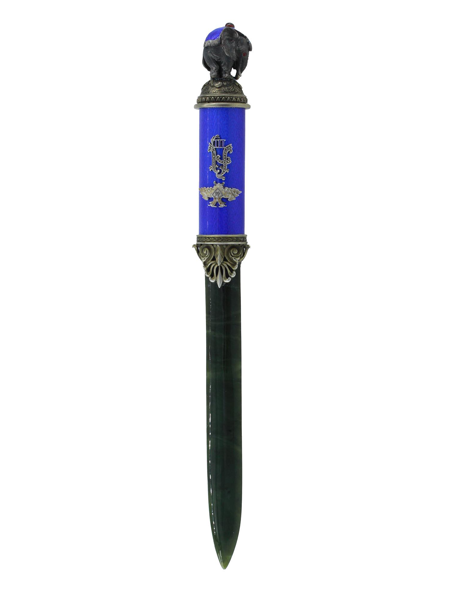 RUSSIAN SILVER ENAMEL NEPHRITE JADE LETTER OPENER: A Russian letter opener with a nephrite jade blade and a silver mounted blue guilloche enameled handle holding the Imperial Warrant set with a diamond and the monogram of Alexandre III. With a silver 