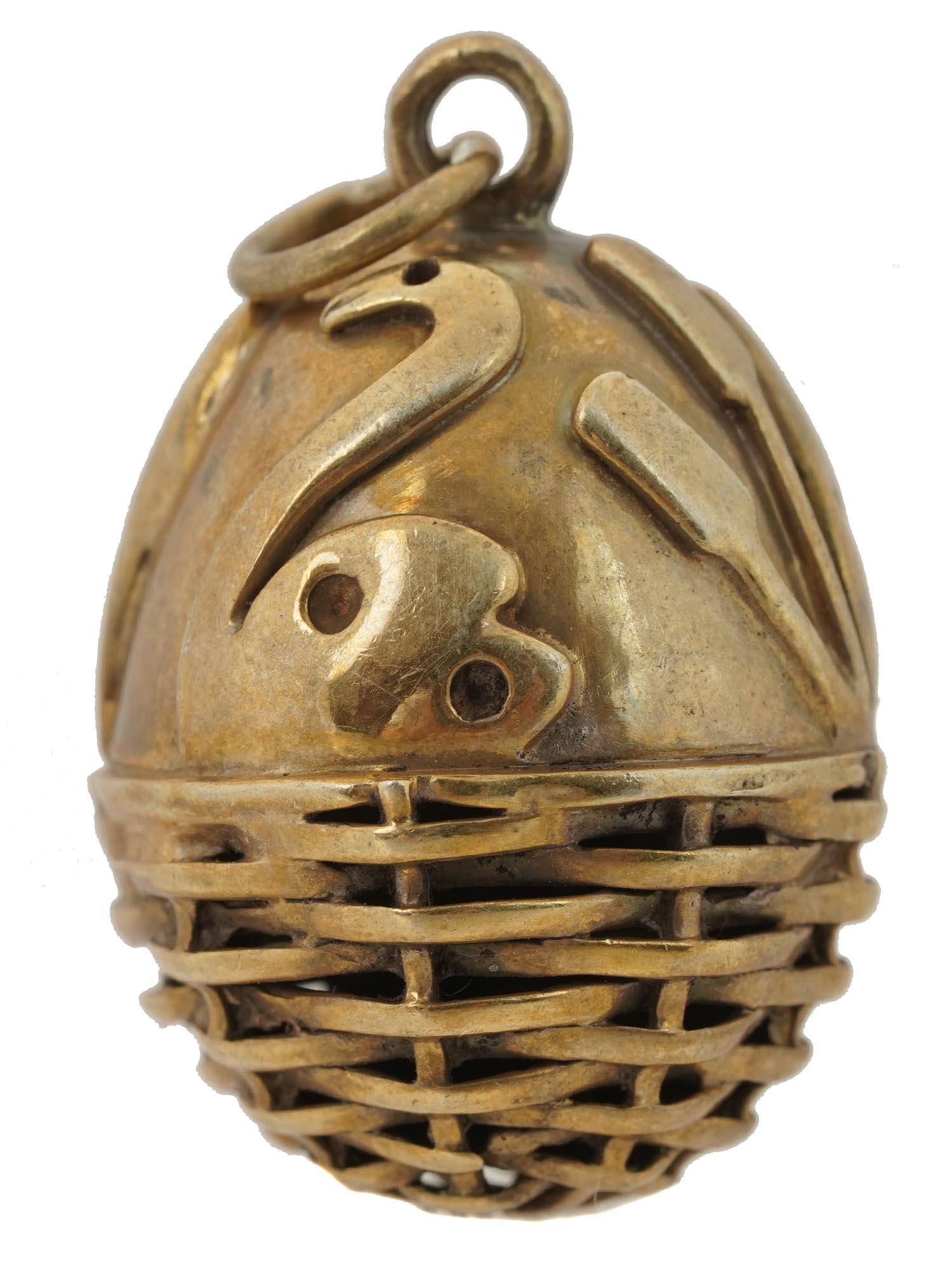RUSSIAN GILT SILVER EGG PENDANT WITH SWAN: Russian gilt silver egg pendant. The bottom of the egg is executed in the form of a basket, and the top has carved silhouettes of swans and cranes. Hallmarks on the loop: 88 silver standard, master's 