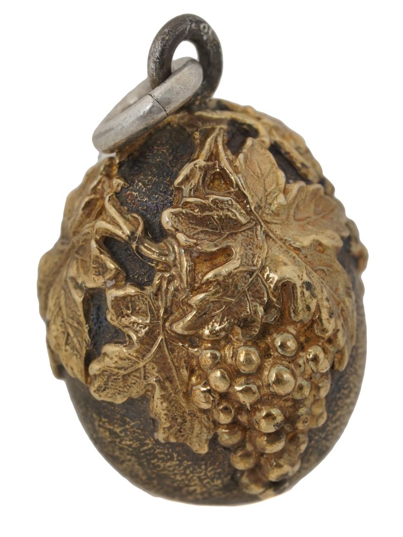 RUSSIAN GILT SILVER EGG PENDANT WITH GRAPE LEAVES: Russian gilt silver egg pendant decorated with carved grape leaves. Hallmarks on the loop: 84 silver standard, master's initials AT. Weight - 10.5 grams. Collectible Russian Silver Jewelry. Dimensions