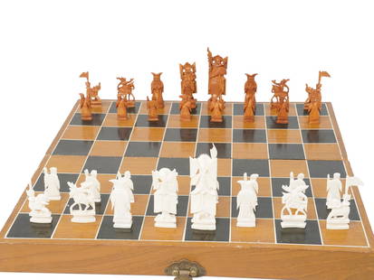 VINTAGE ORIENTAL CHINESE HAND CARVED CHESS GAME: A vintage Chinese chess game set nicely hand carved of natural materials. Complete with a wooden lacquered case with brass fittings and blue velvet lining. Collectible Vintage Figural Chess, Cabinet D