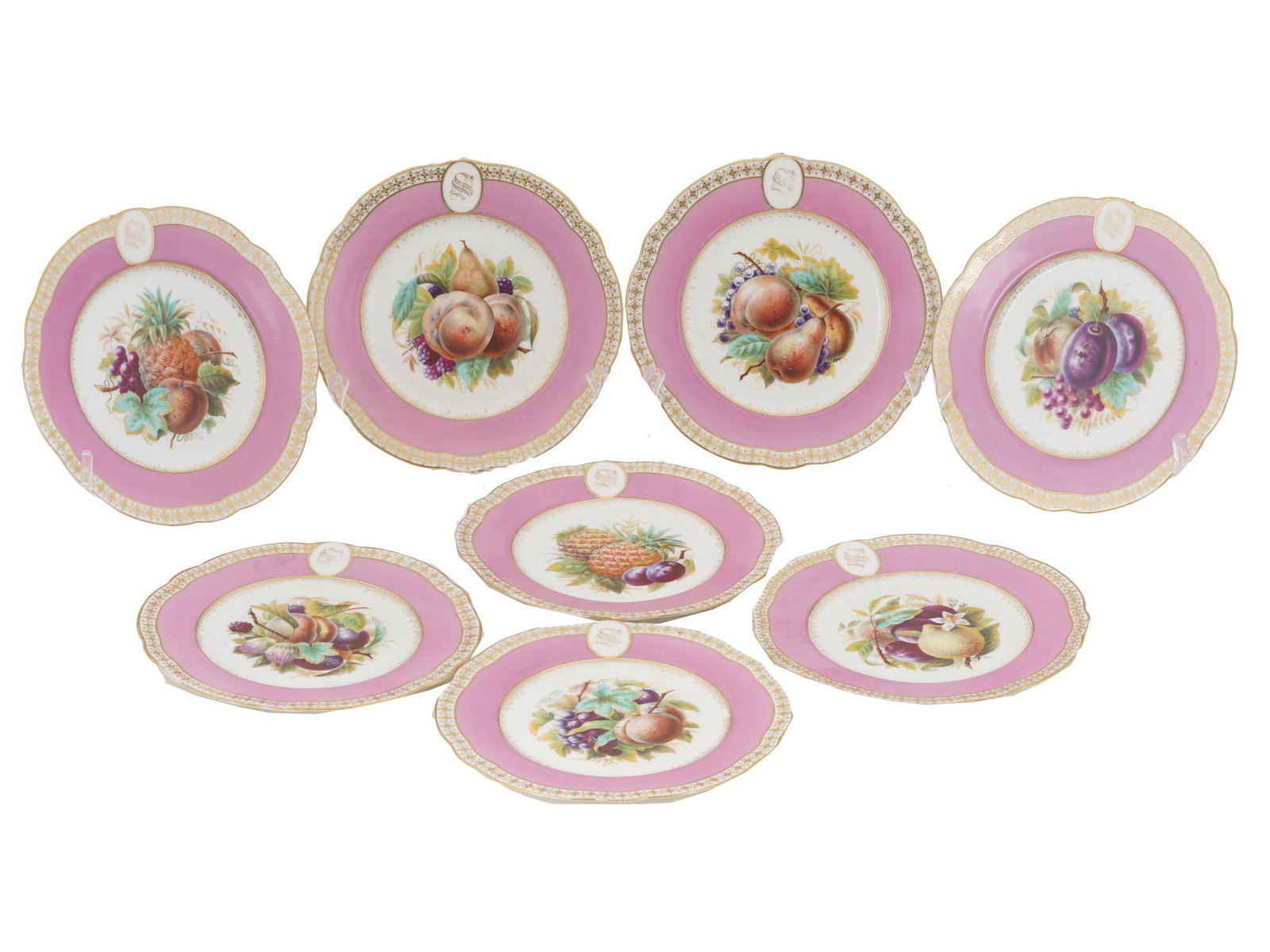 ANTIQUE PORCELAIN PLATES WITH HAND PAINTED FRUITS: A set of eight antique Copeland botanical plates decorated with hand-painted fruits on a white reserve surrounded by a dark pink band and gilt trim with the letter S. Signed on verso Mc Leewe and Putn